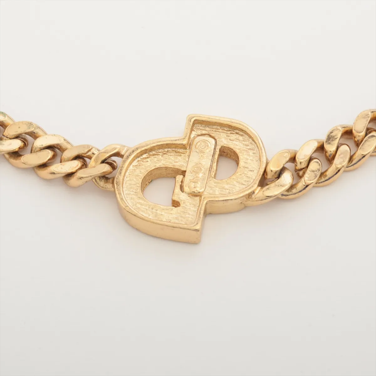 CD logo bracelet, gold plated with rhinestones. Shows signs of wear including — view 3