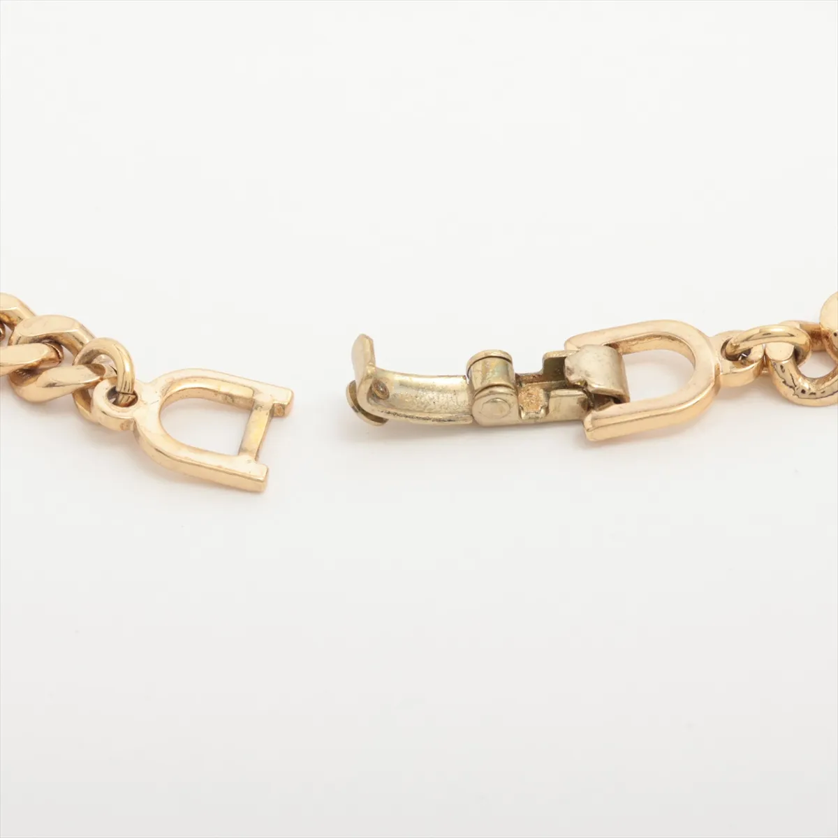 CD logo bracelet, gold plated with rhinestones. Shows signs of wear including — view 4