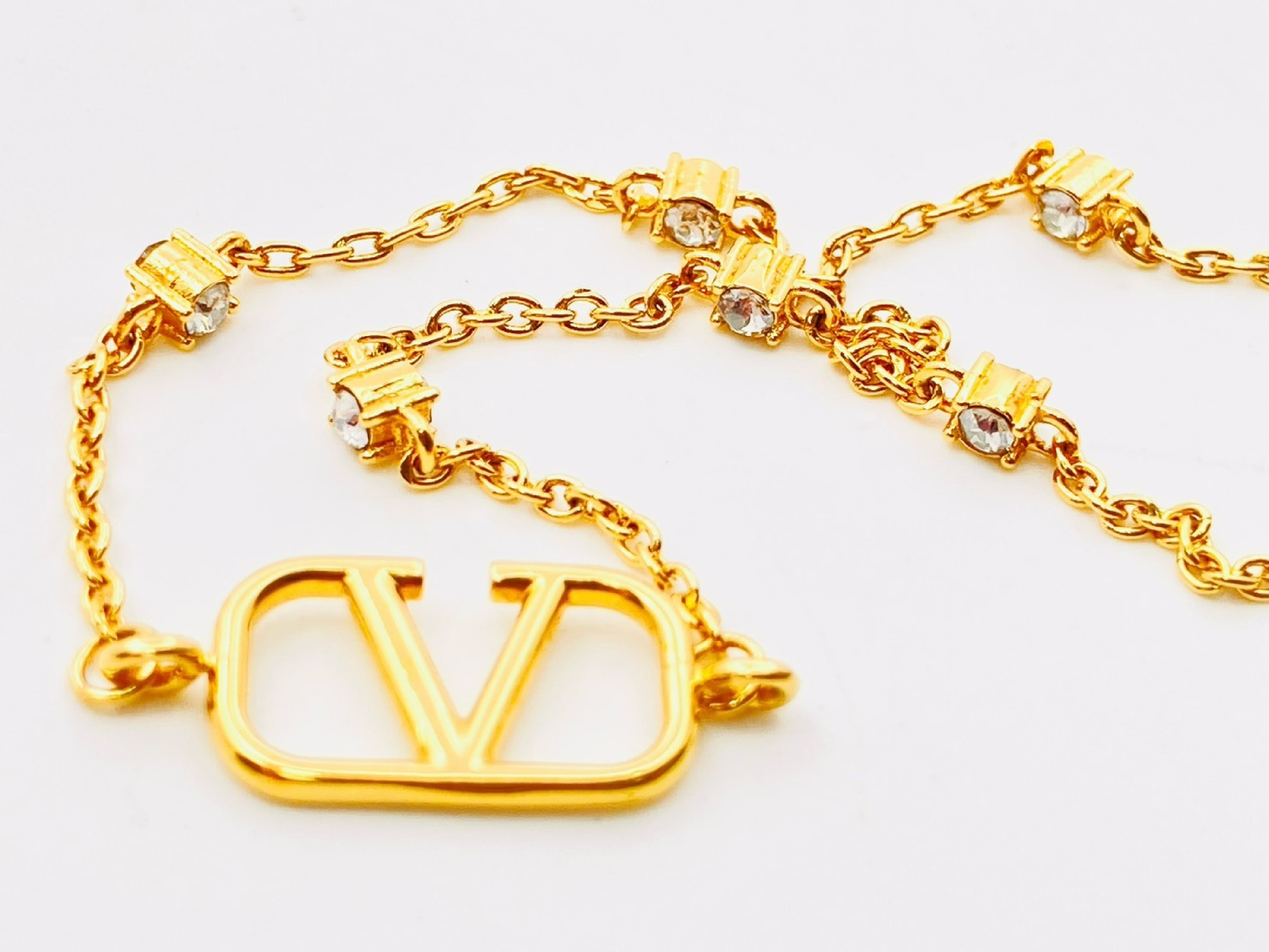 V-logo signature Swarovski crystal rhinestone bracelet, gold bracelet/bangle — view 2
