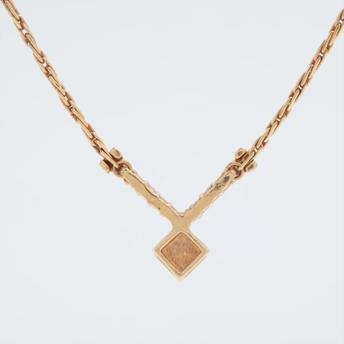logo necklace, gold plated with rhinestones, black and gold. Shows signs of wear, including — view 2
