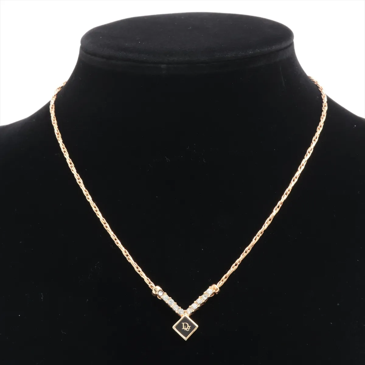 logo necklace, gold plated with rhinestones, black and gold. Shows signs of wear, including — view 5