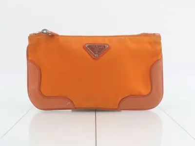 Nylon and leather triangular plate pouch, orange tones.
