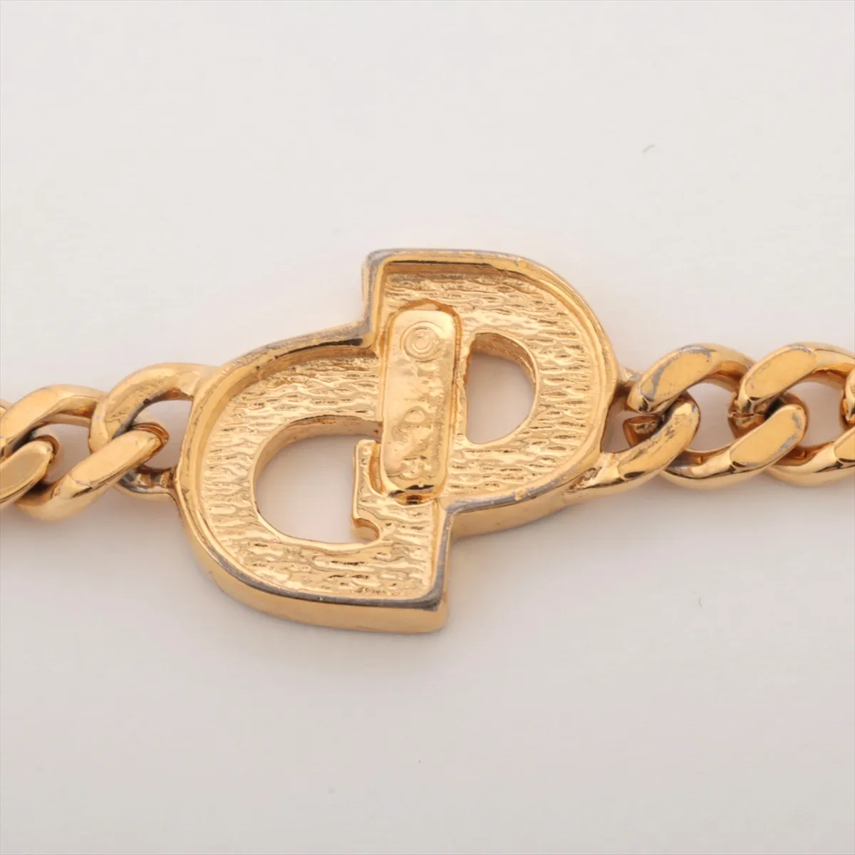 CD logo bracelet, gold plated with rhinestones. Shows signs of wear, including — view 3