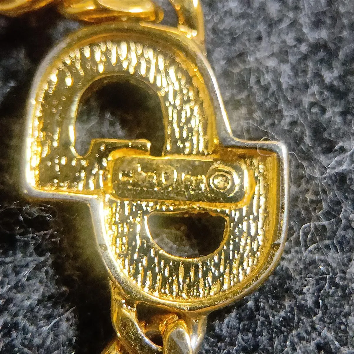 CD logo bracelet, gold plated with rhinestones. Shows signs of wear, including — view 6