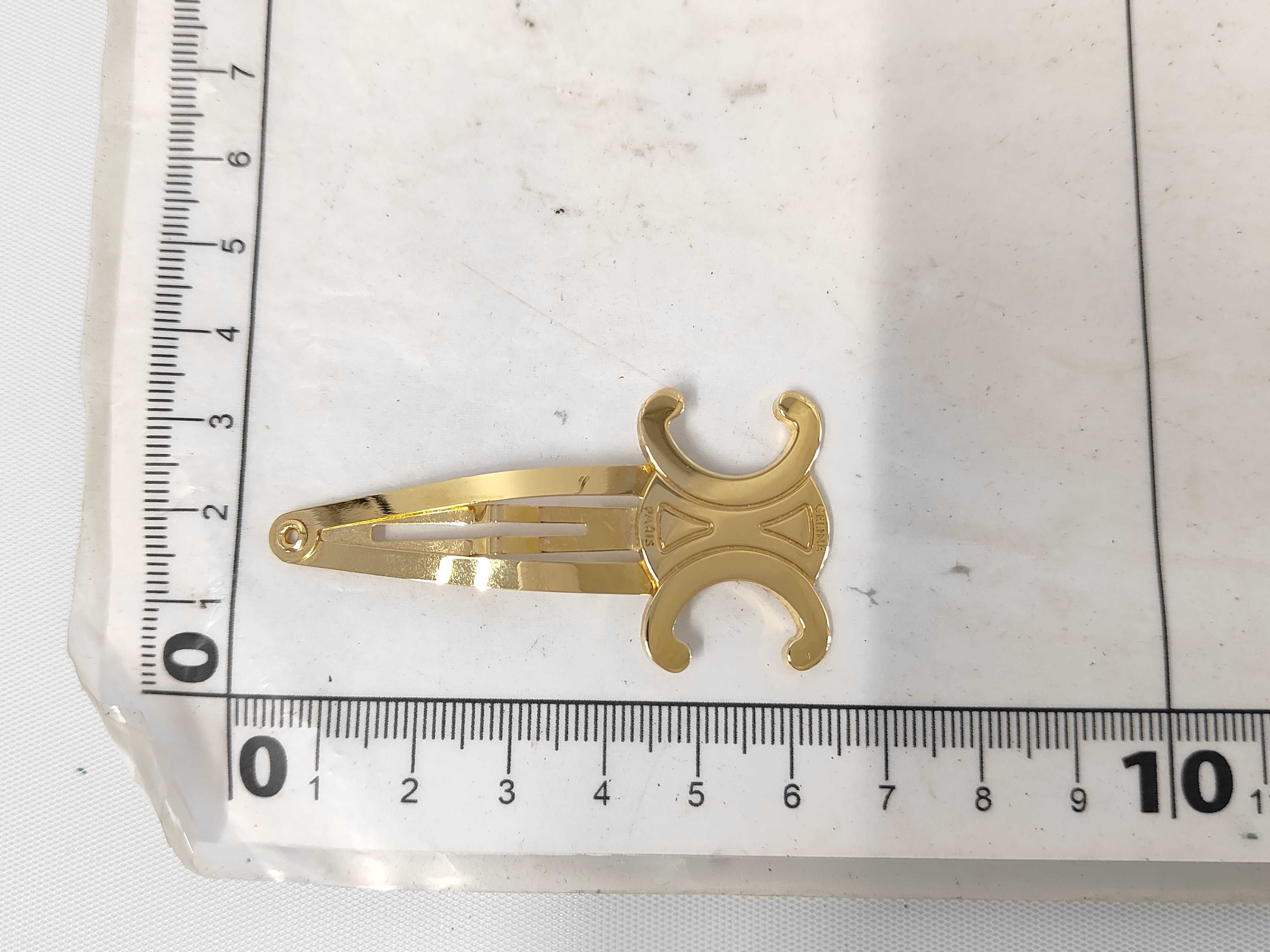 Triomphe Hair Clip. Includes: Box, dust bag, and hair accessory. — view 7