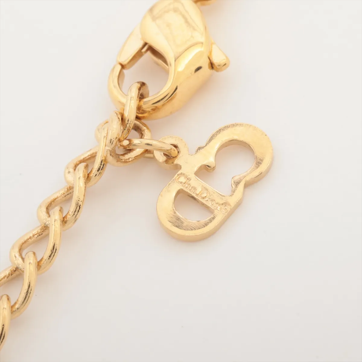 necklace, gold plated with rhinestones. Shows wear, tarnishing, and stains. — view 4