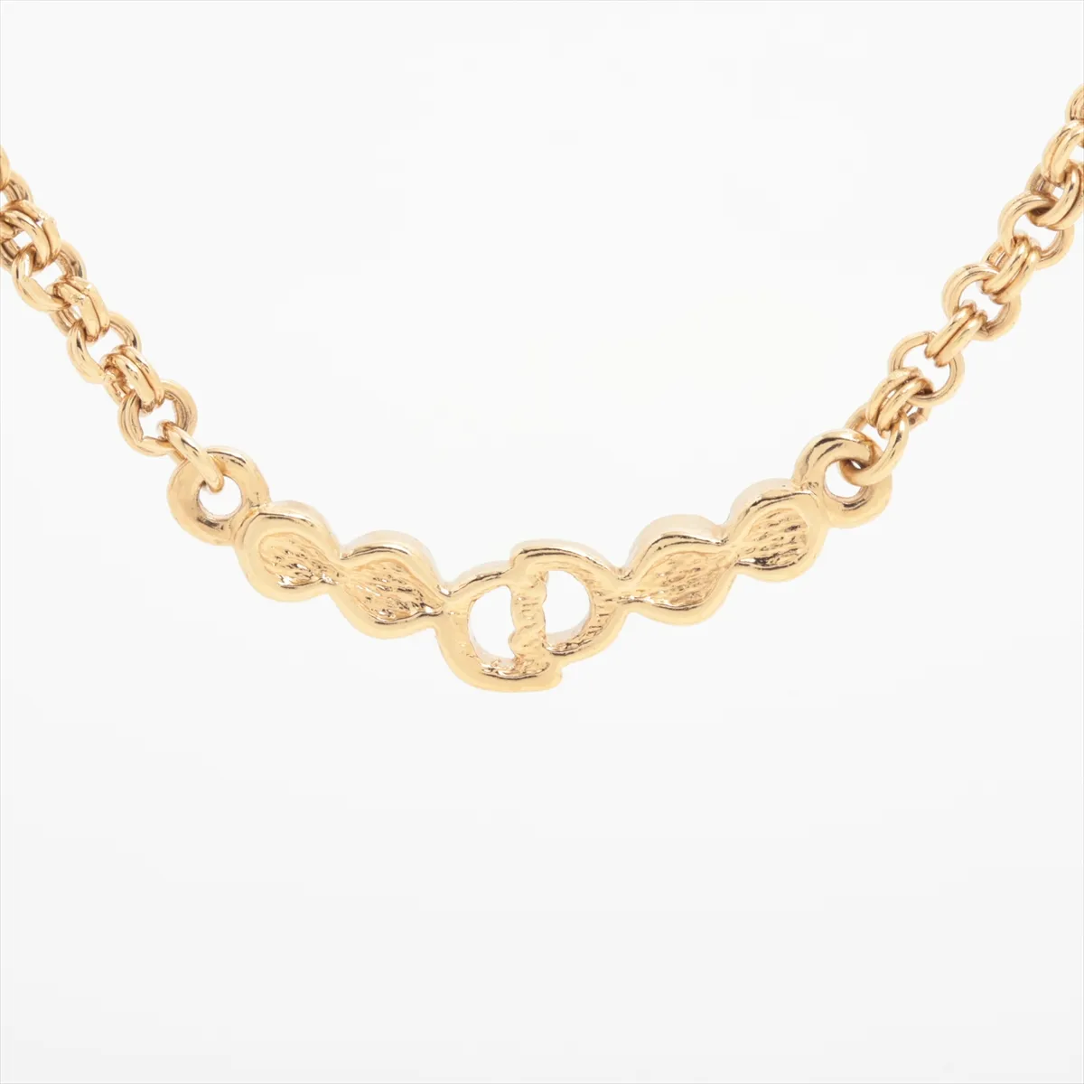CD logo necklace, gold plated with rhinestones. Shows signs of wear, including — view 2