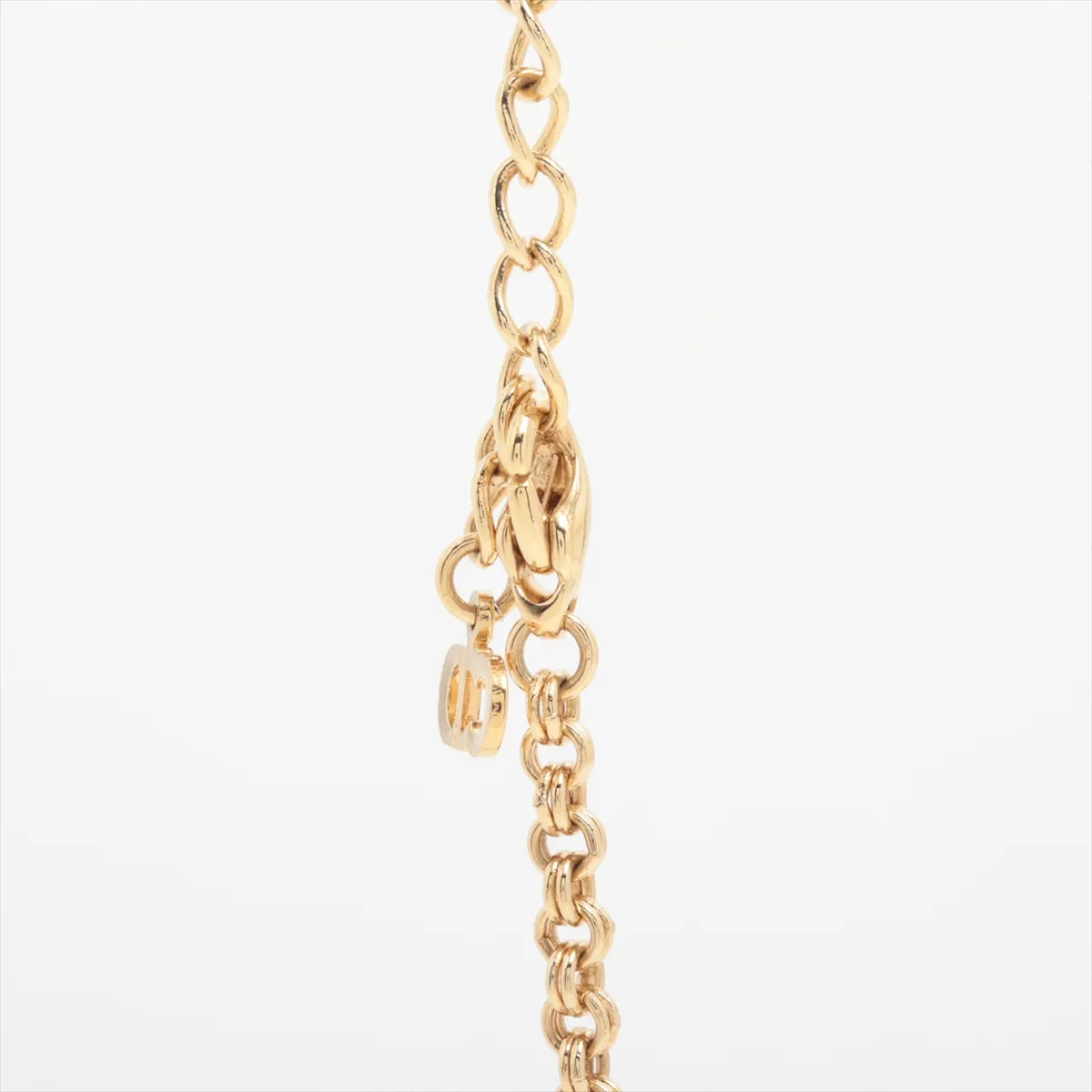 CD logo necklace, gold plated with rhinestones. Shows signs of wear, including — view 3