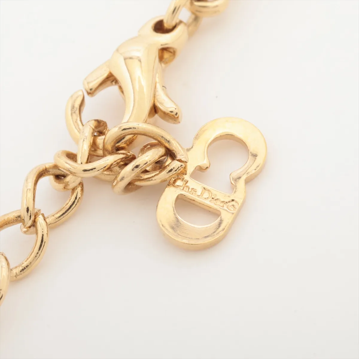 CD logo necklace, gold plated with rhinestones. Shows signs of wear, including — view 4