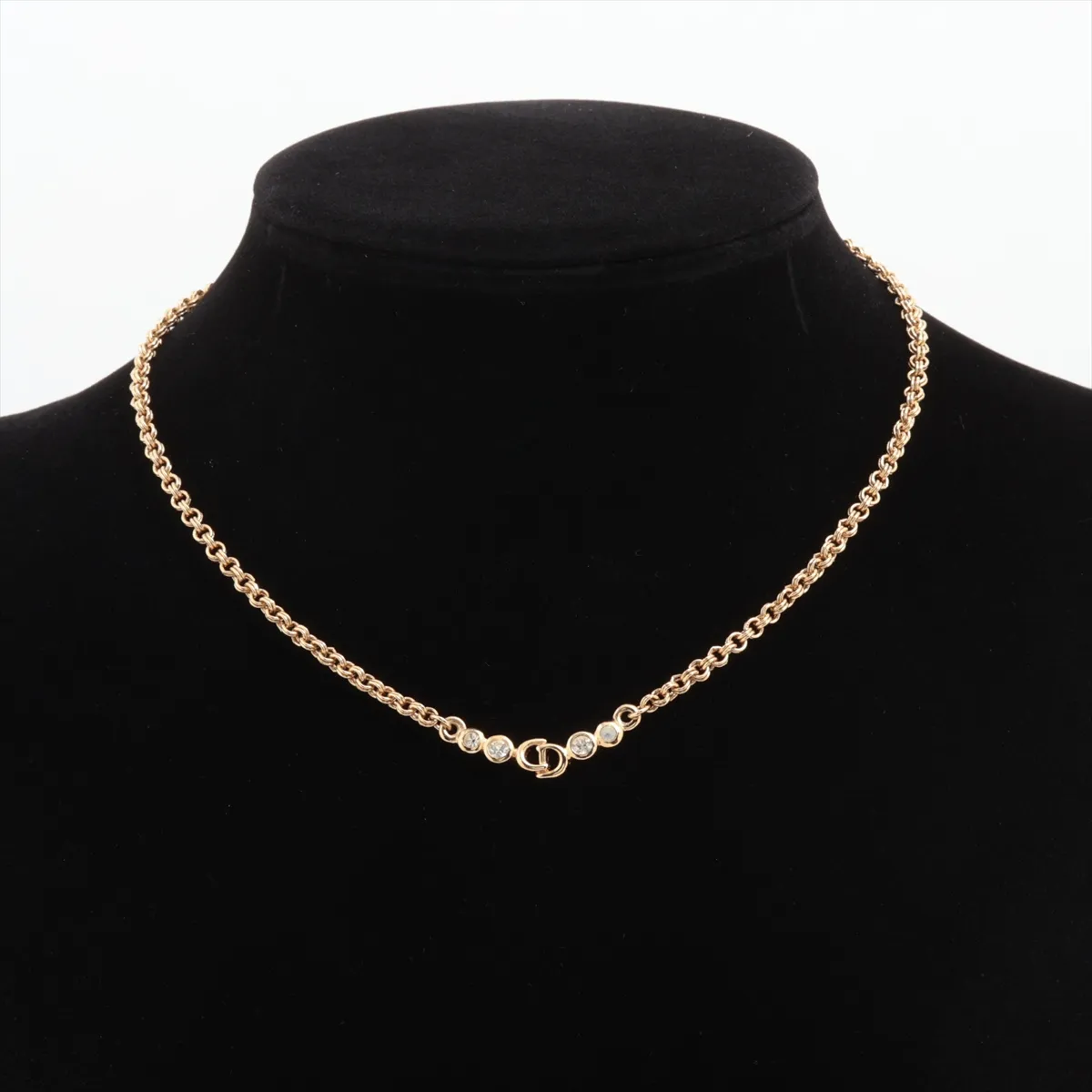 CD logo necklace, gold plated with rhinestones. Shows signs of wear, including — view 5