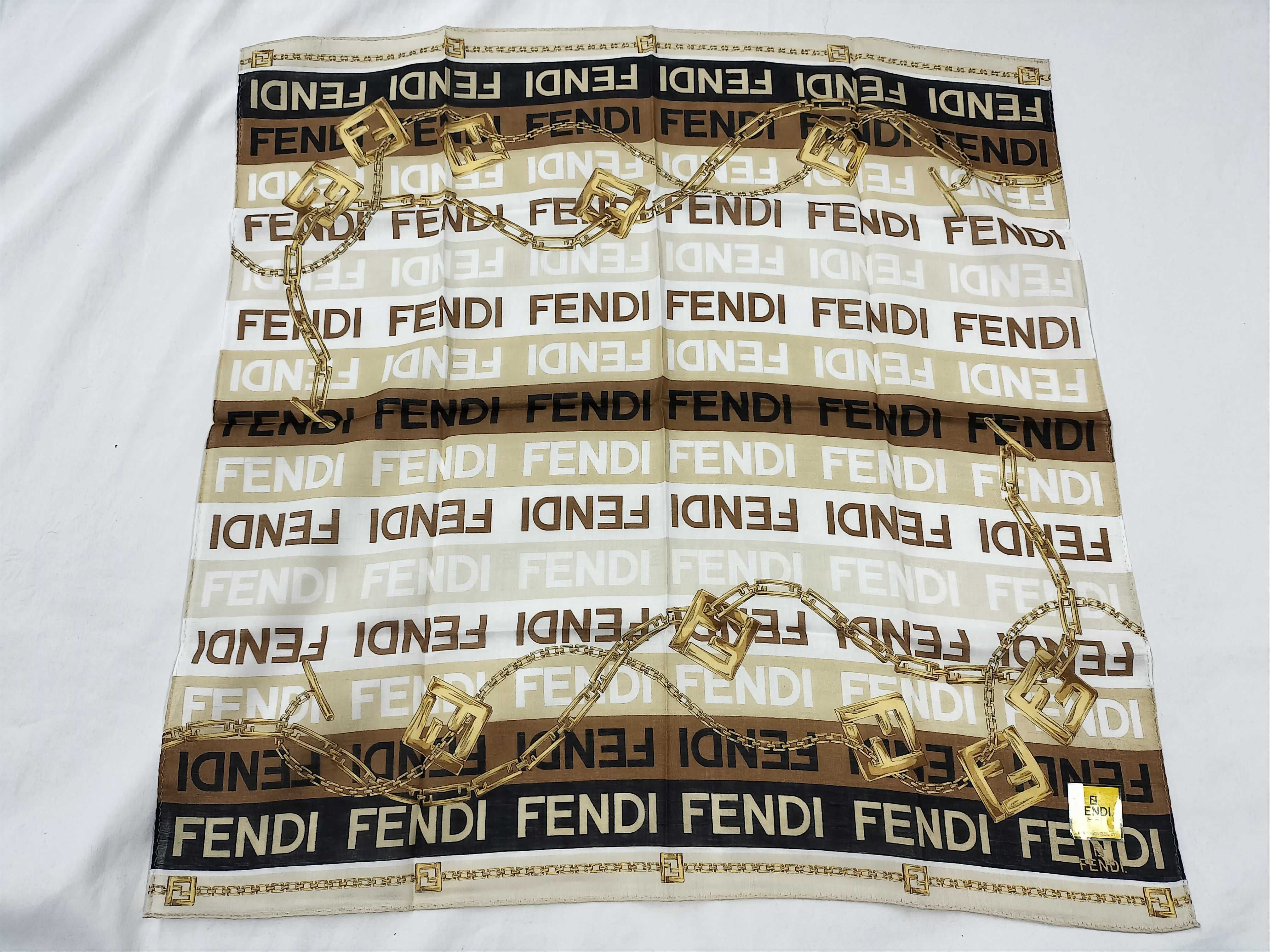 Zucca pattern Fendi handkerchief scarf with sticker, all-over logo print FF Zucca chain, and other accessories.