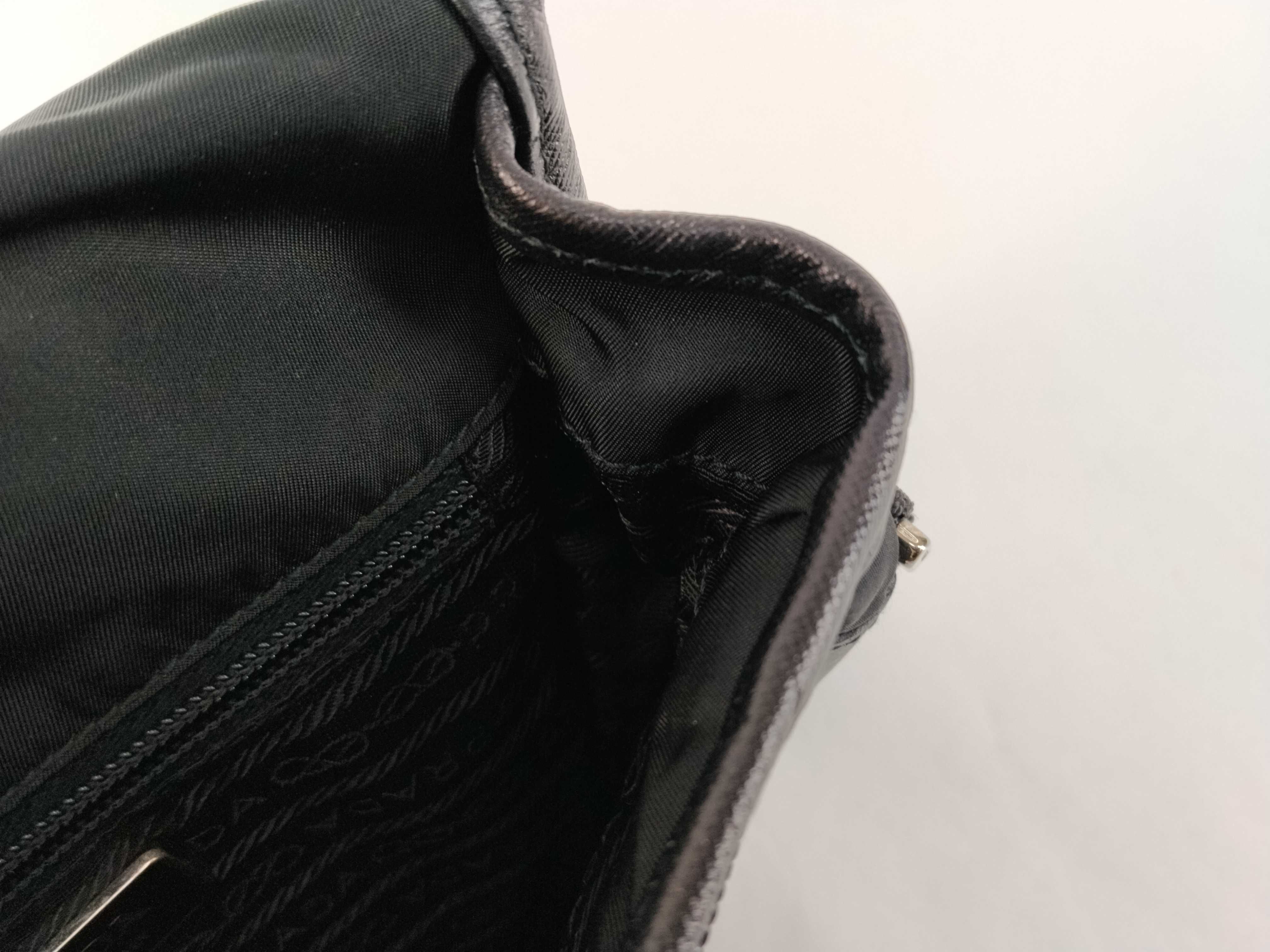 nylon shoulder bag with triangular logo plate, black nylon, white tag, and dust bag. — view 14