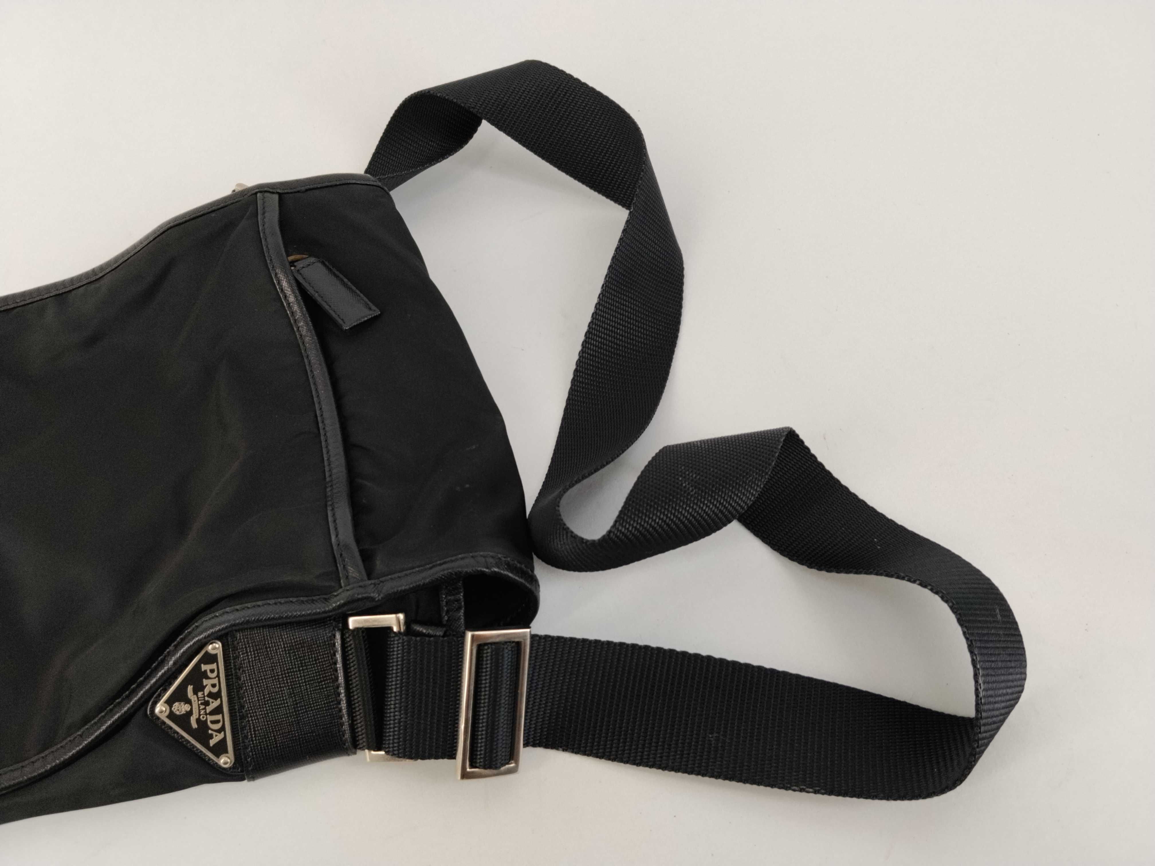 nylon shoulder bag with triangular logo plate, black nylon, white tag, and dust bag. — view 3