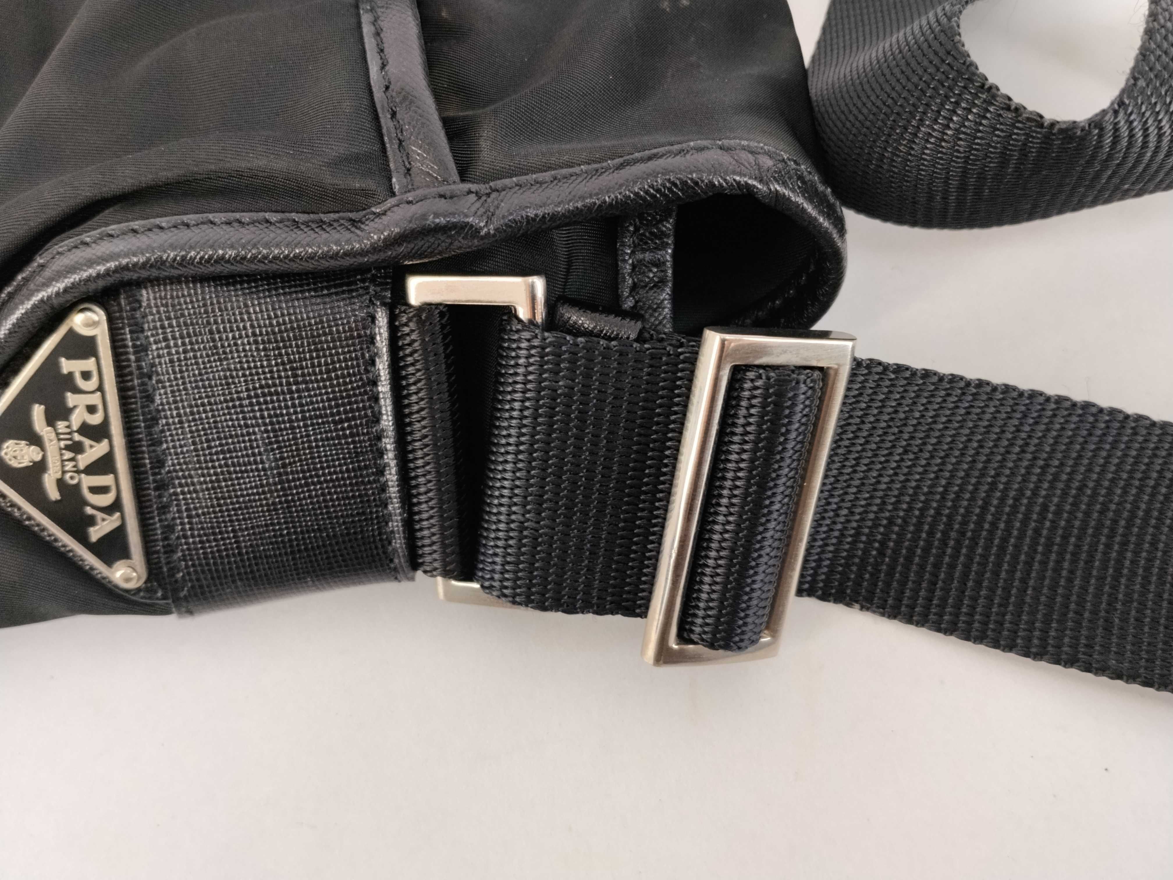 nylon shoulder bag with triangular logo plate, black nylon, white tag, and dust bag. — view 5