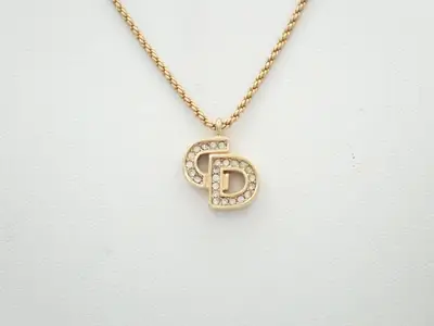 CD logo necklace with rhinestones, chain approximately 42cm long.