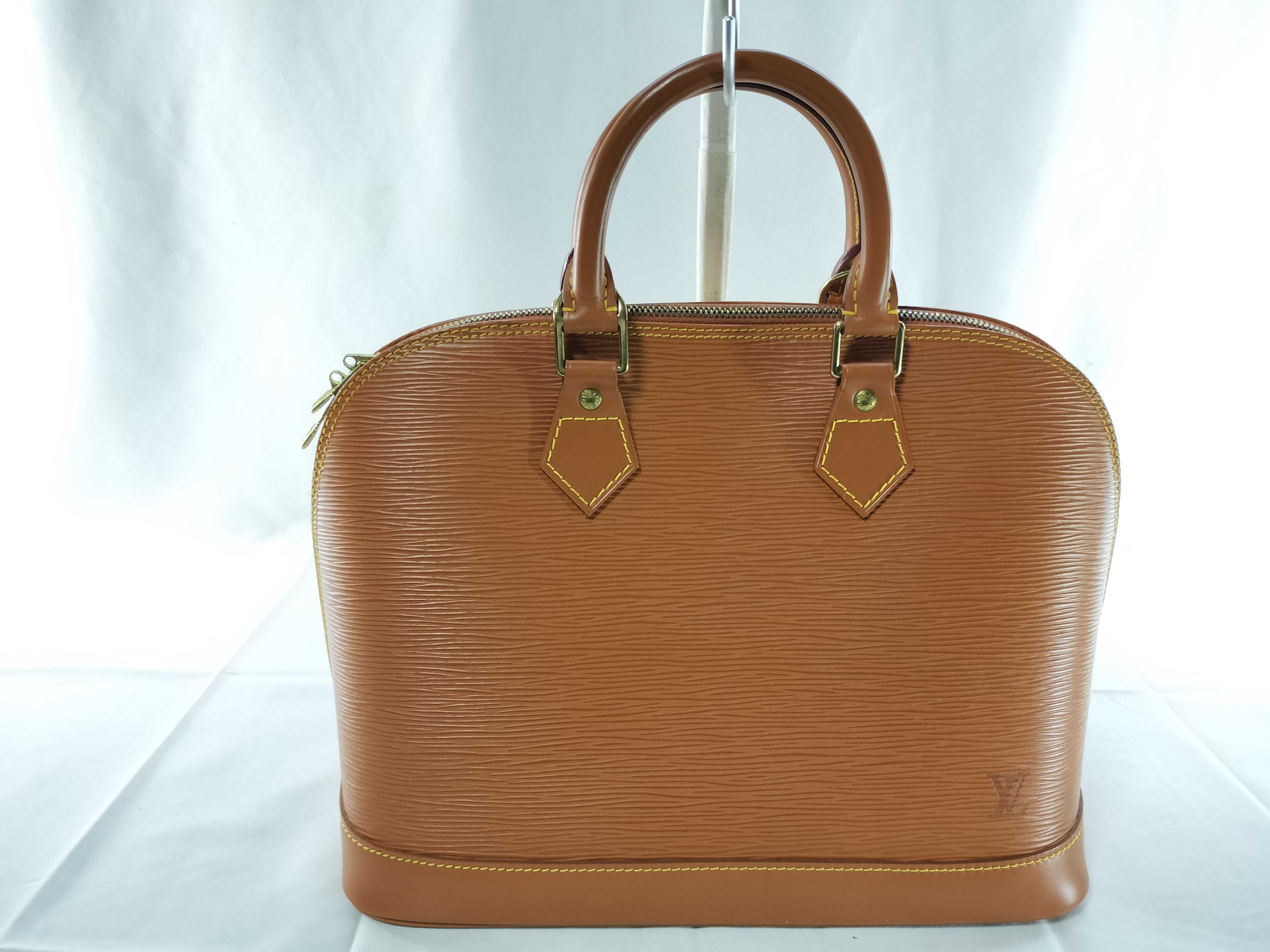 Epi Alma PM Brown Handbag
