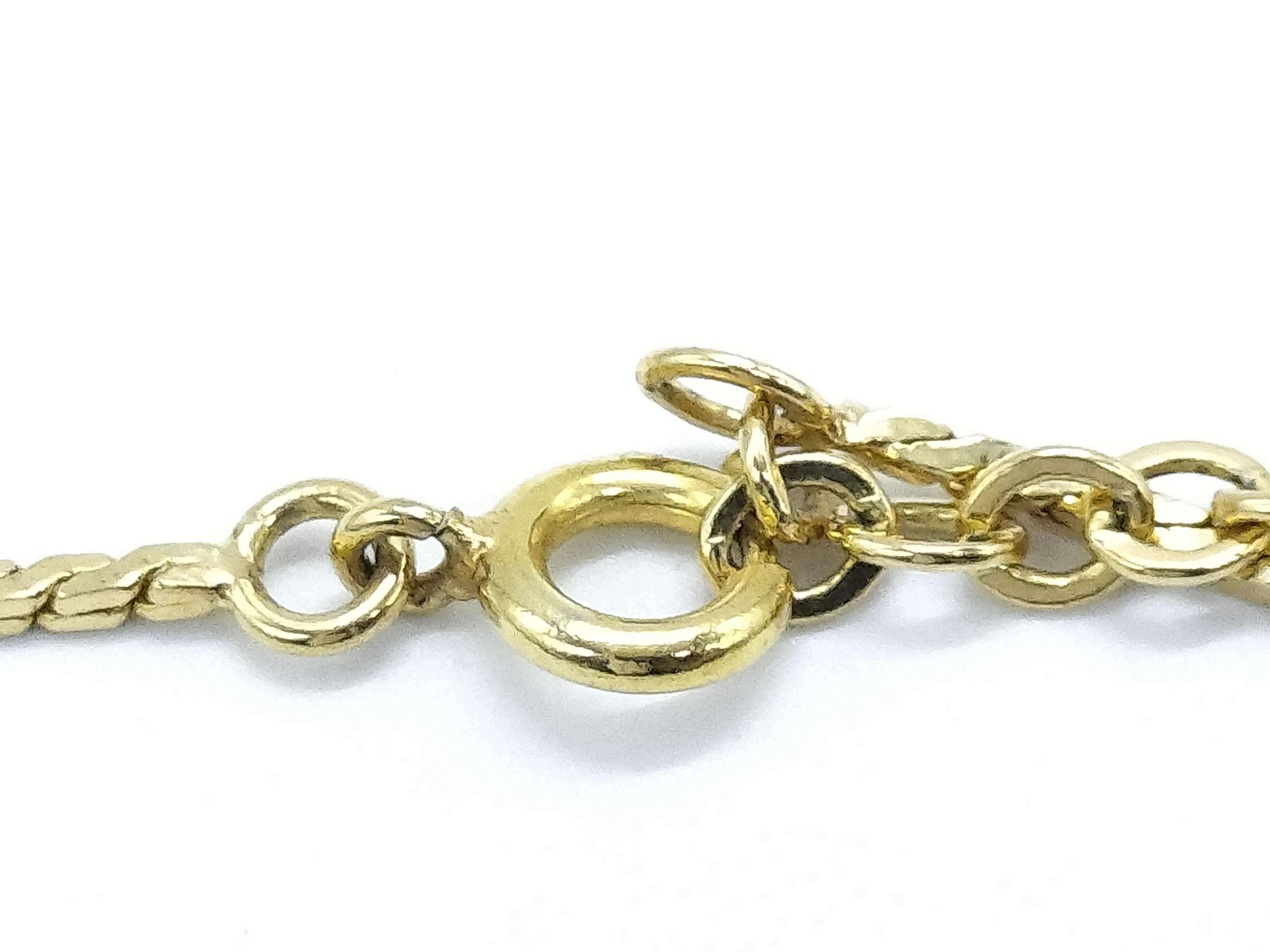 gold-colored necklace with CD logo and gemstone. — view 5