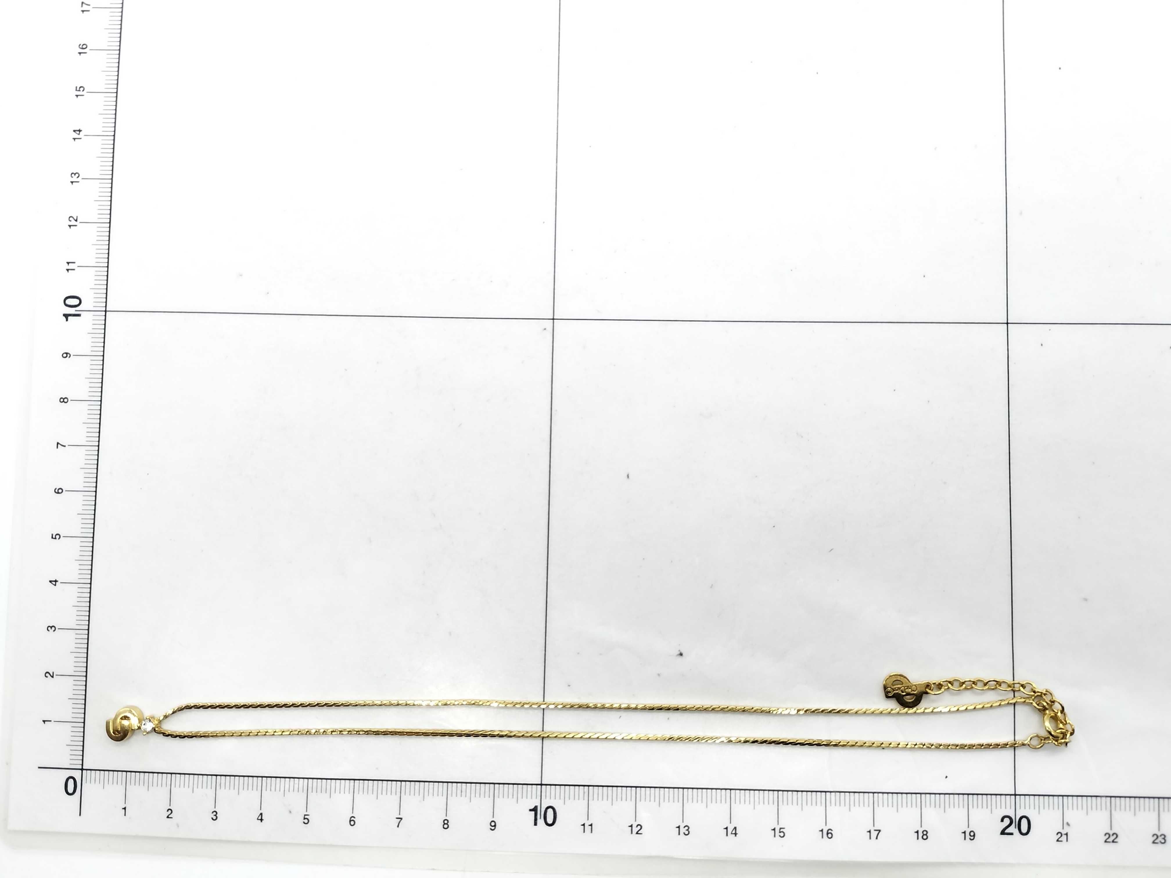 gold-colored necklace with CD logo and gemstone. — view 7