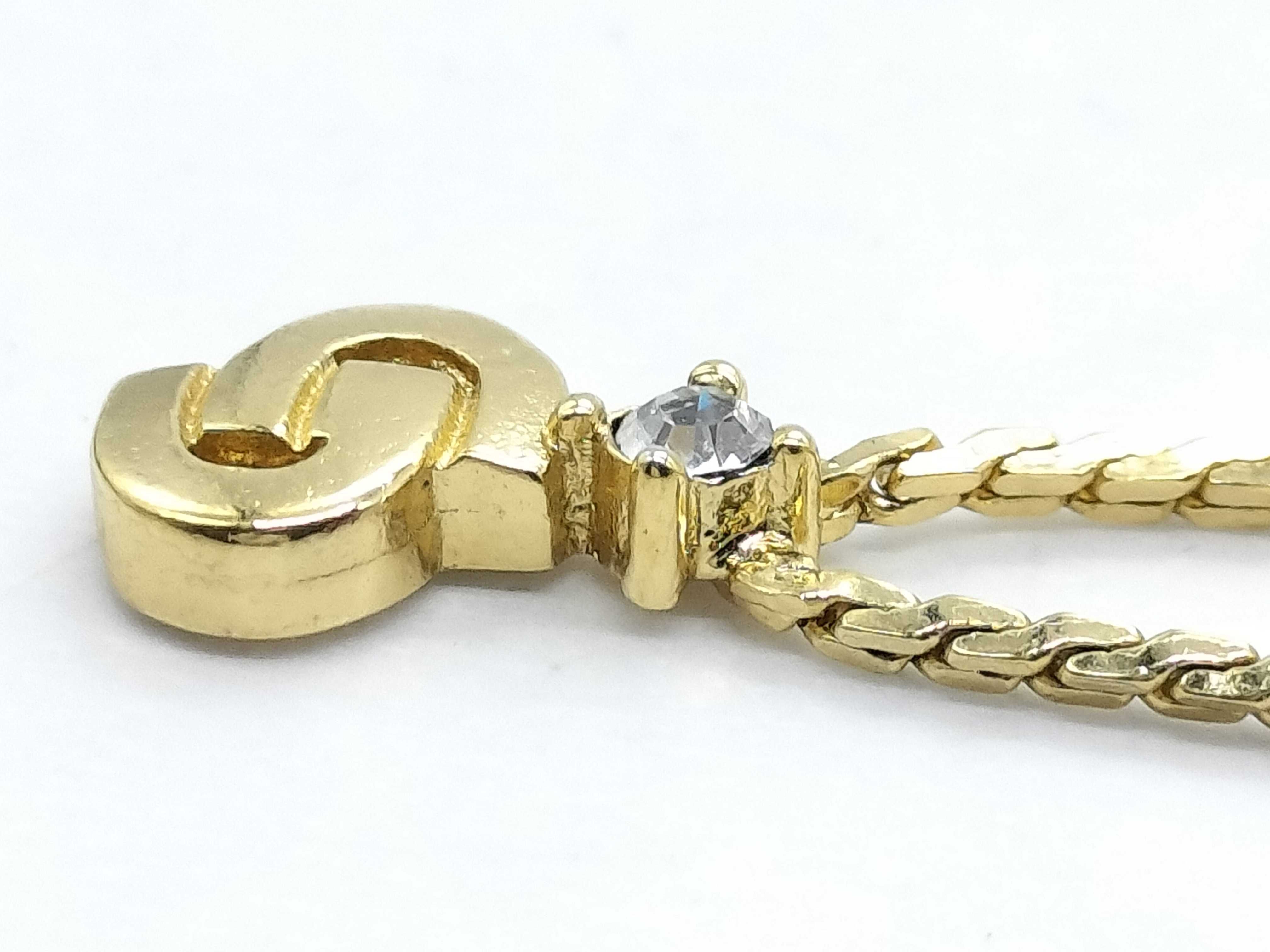 gold-colored necklace with CD logo and gemstone. — view 8