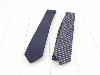 Two unused neckties, stored in their original boxes.