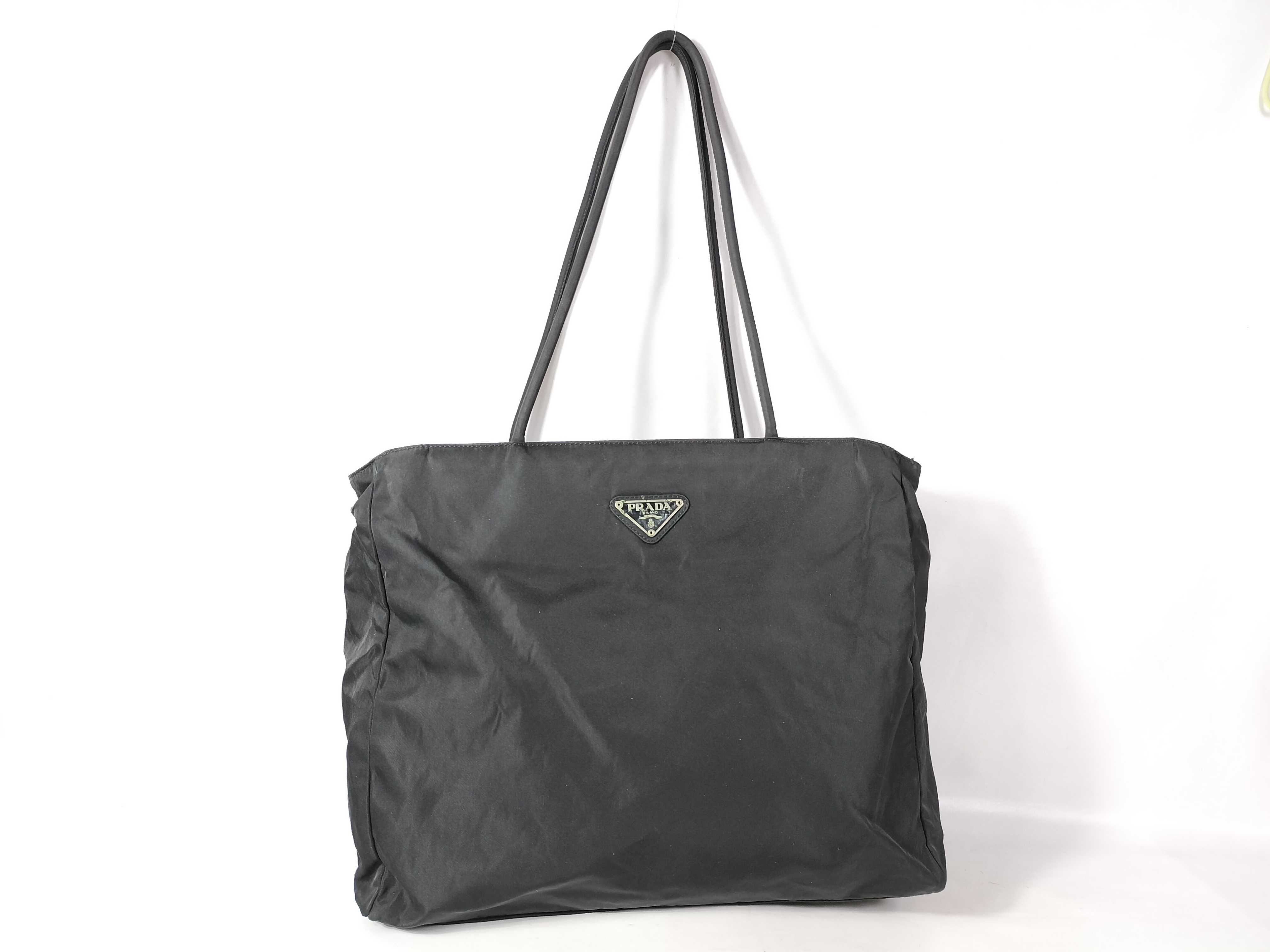 nylon tote bag (white, no tag) and nylon tote bag (black, with triangular logo plate).