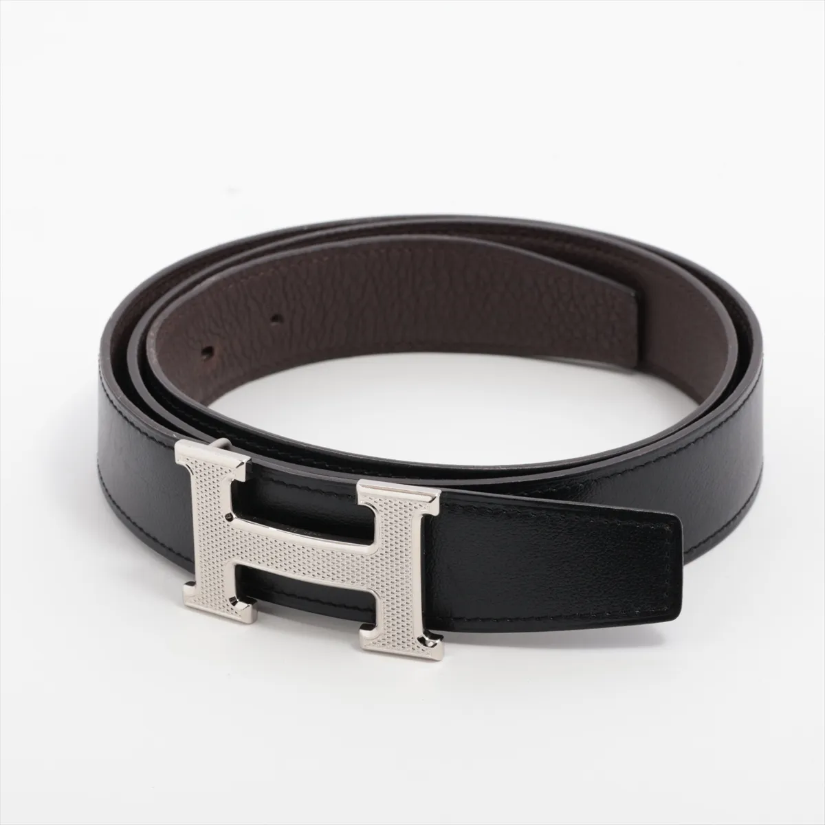 H Guilloché W stamp: 2024 belt, 100 leather, black x brown. Buckle dents,