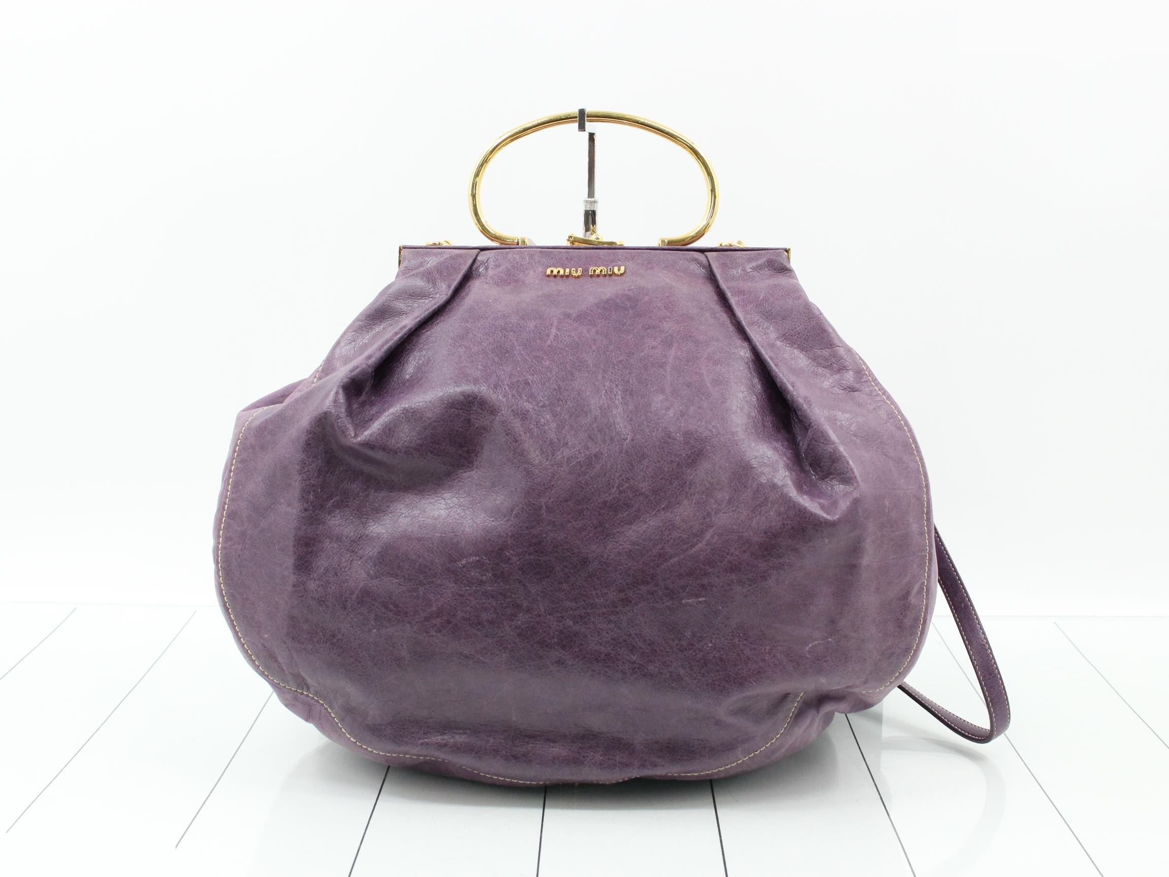 Other lines: 2-way bag with long strap, clasp closure, leather, purple.