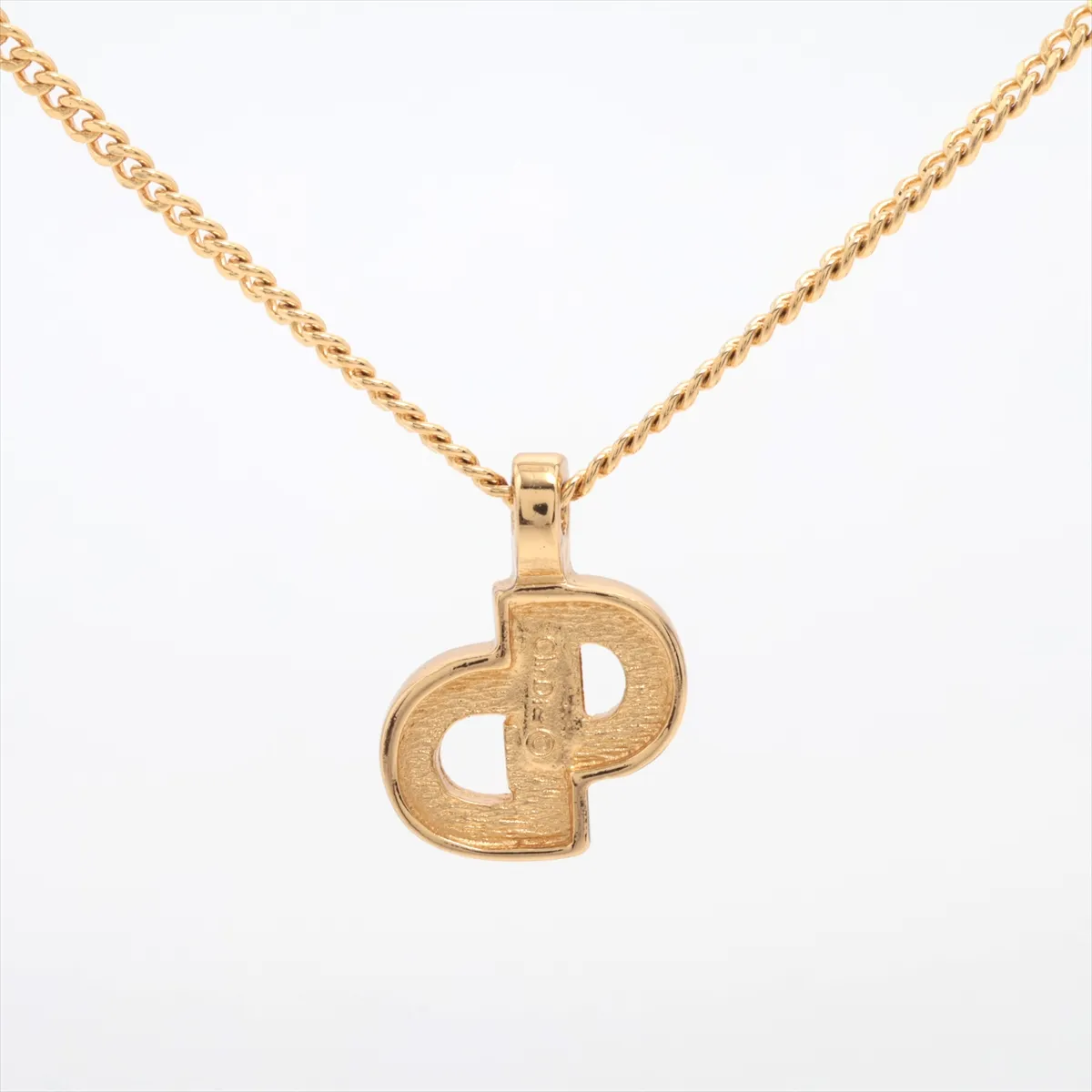 CD logo necklace, gold plated with rhinestones. Shows signs of wear, including — view 2