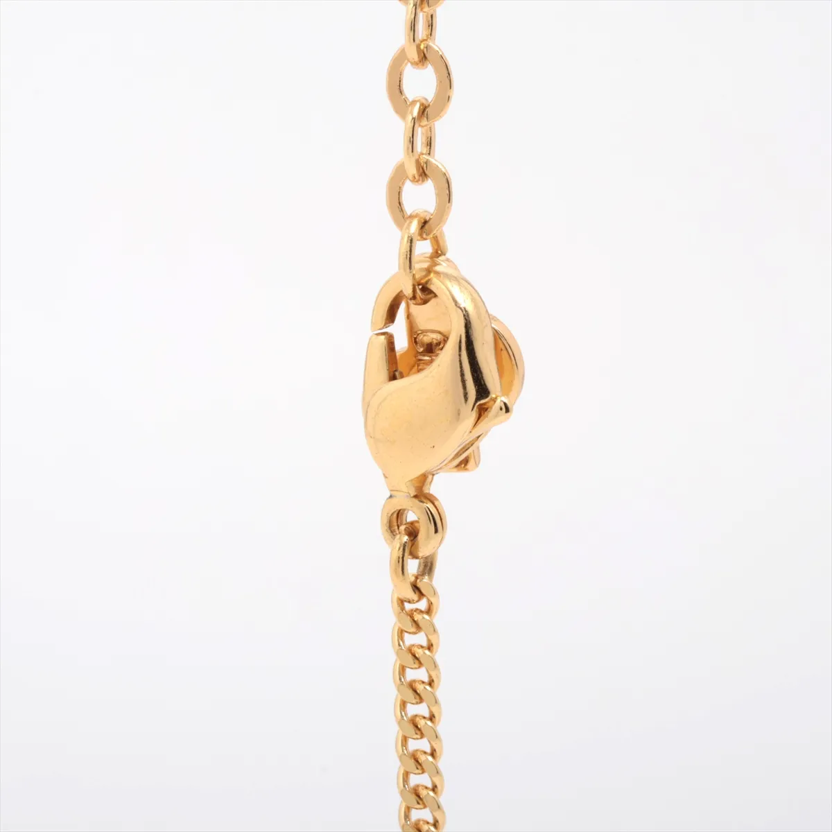CD logo necklace, gold plated with rhinestones. Shows signs of wear, including — view 3