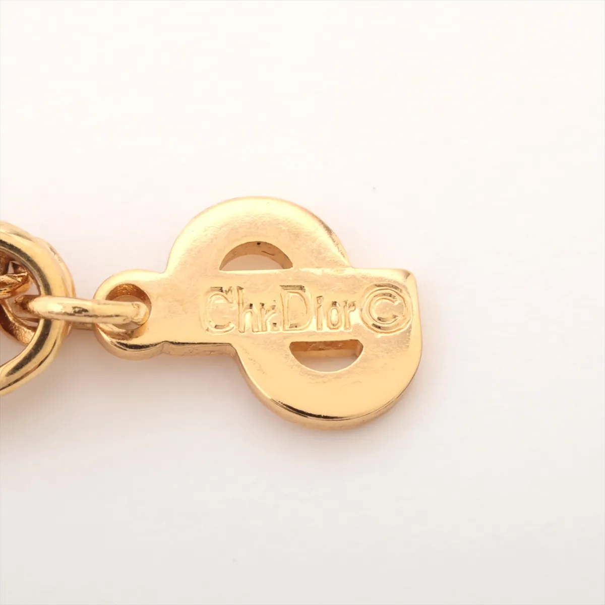 CD logo necklace, gold plated with rhinestones. Shows signs of wear, including — view 4