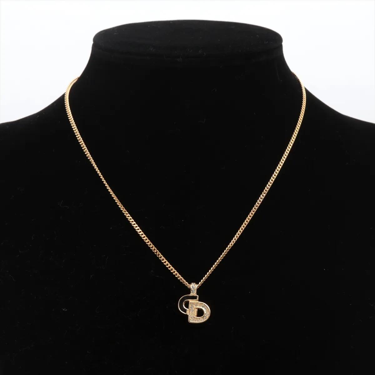 CD logo necklace, gold plated with rhinestones. Shows signs of wear, including — view 5