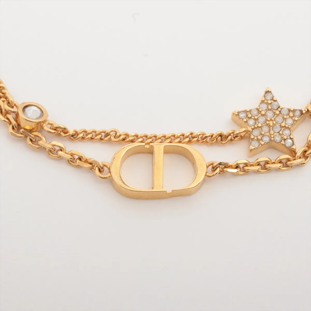 Petit CD bracelet, gold-plated with rhinestones. Shows signs of wear including — view 2