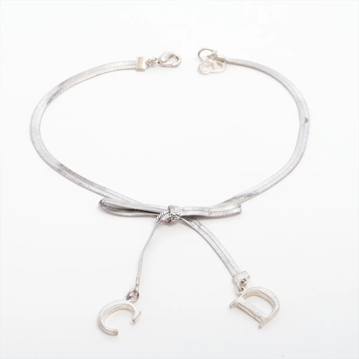 CD Ribbon Bracelet, Metal, Silver. Shows signs of wear,