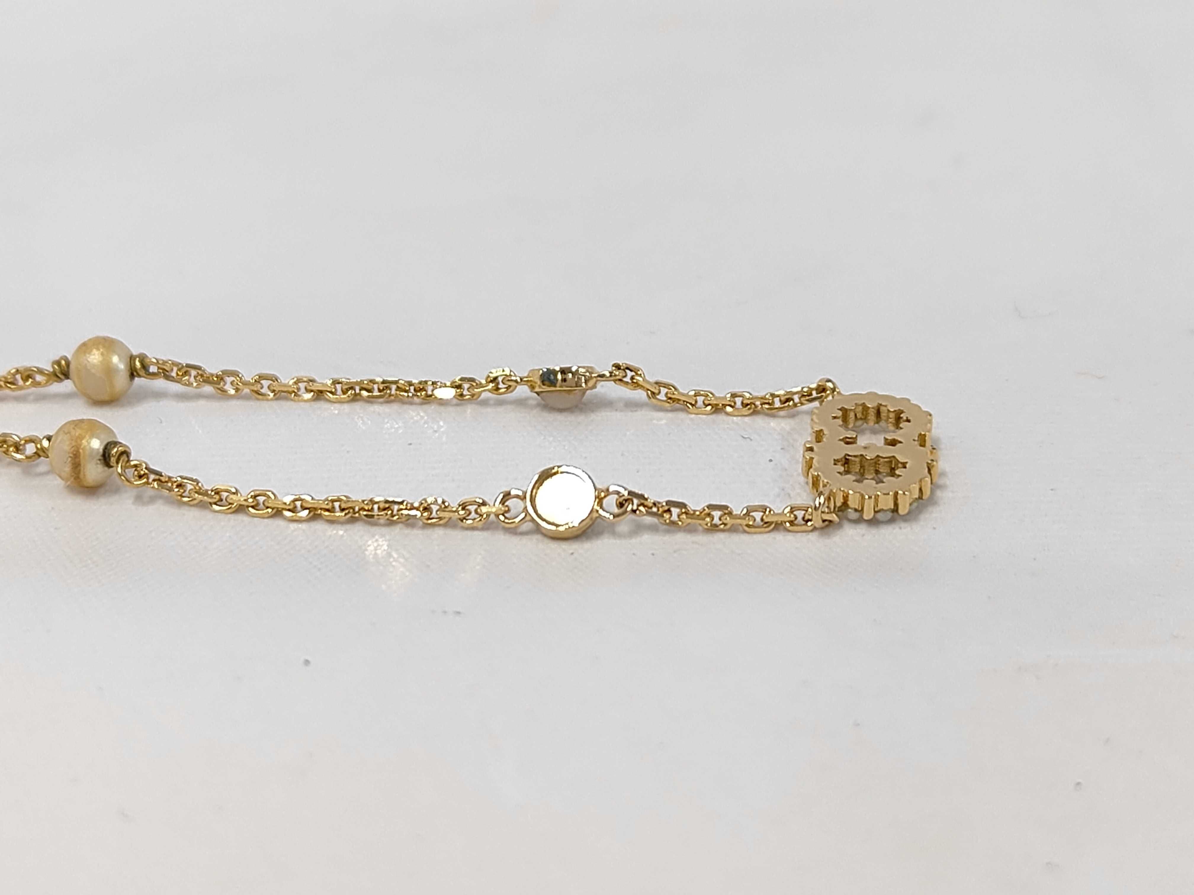 necklace with logo, pearl, and gold accents. — view 3