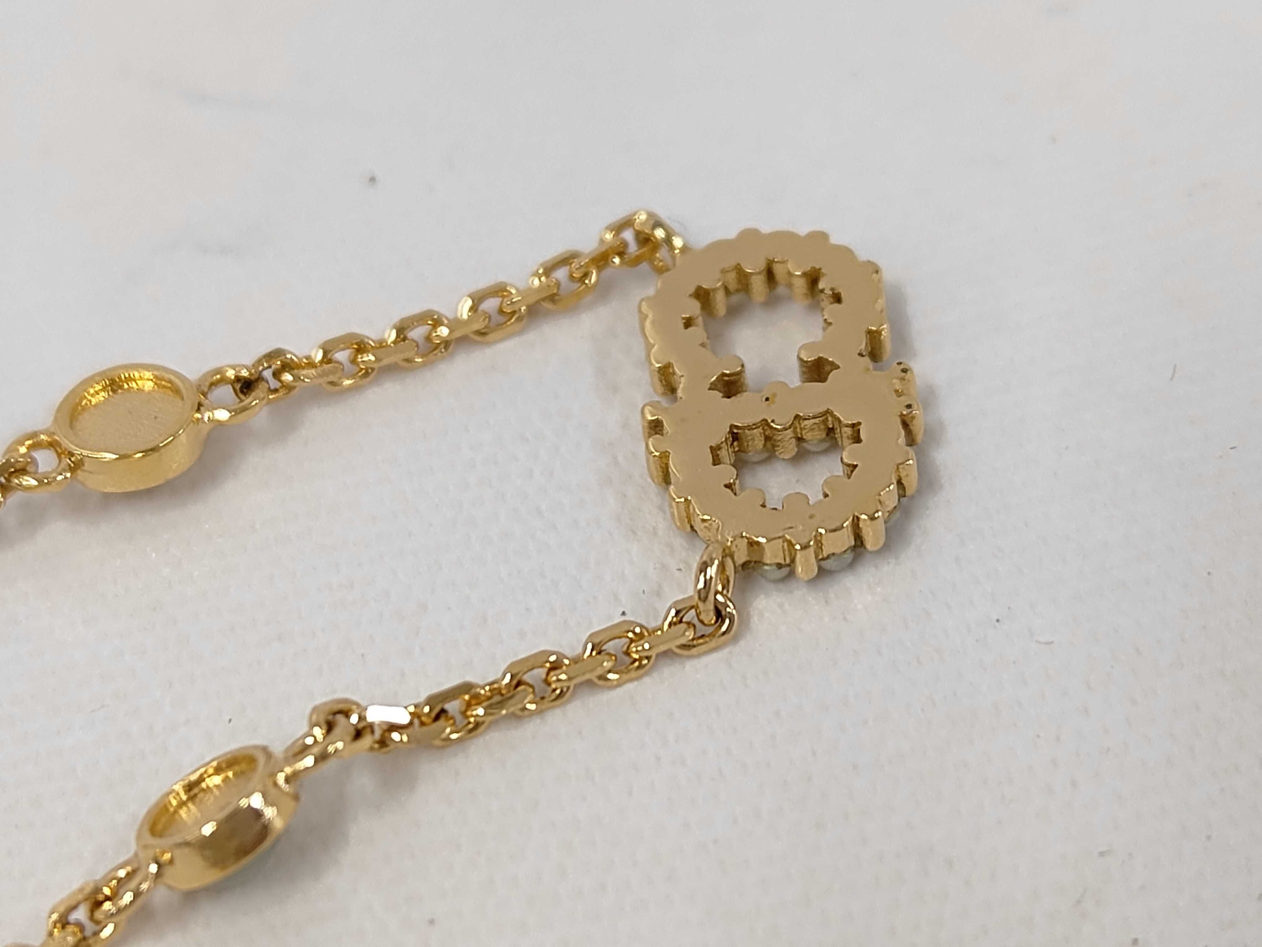 necklace with logo, pearl, and gold accents. — view 6
