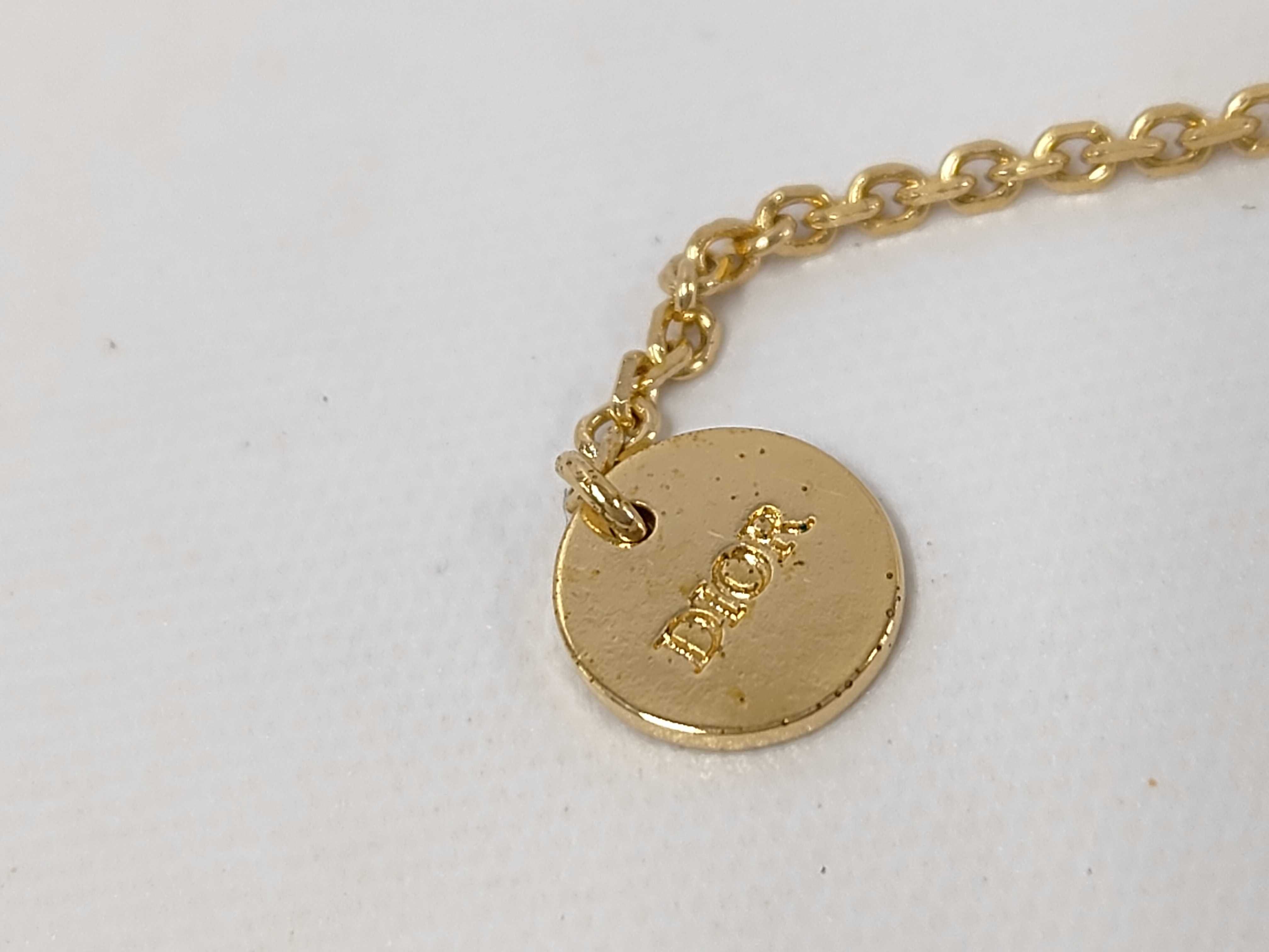 necklace with logo, pearl, and gold accents. — view 7