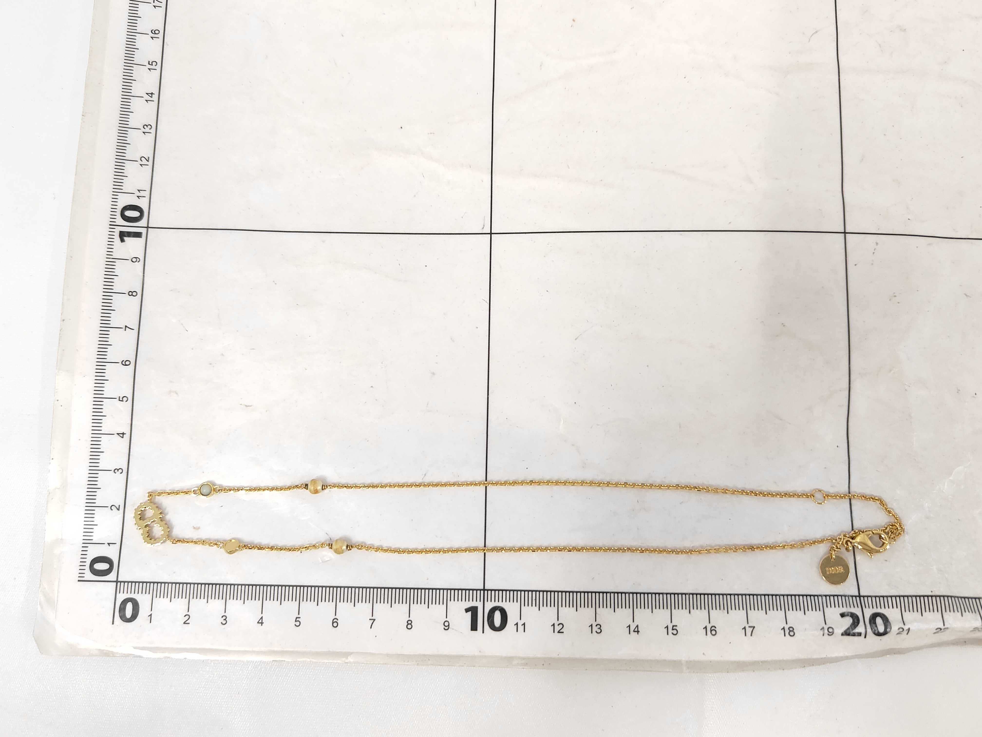 necklace with logo, pearl, and gold accents. — view 10