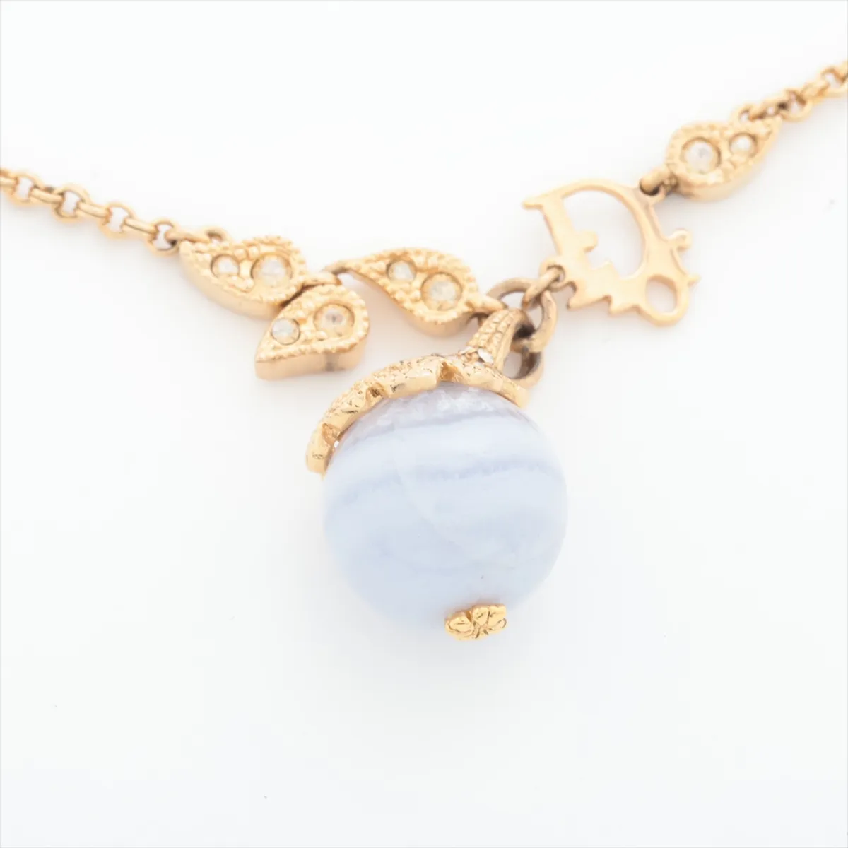 logo bracelet, gold-plated with rhinestones and colored stones, blue and gold. Shows wear, tarnishing, and discoloration. — view 2