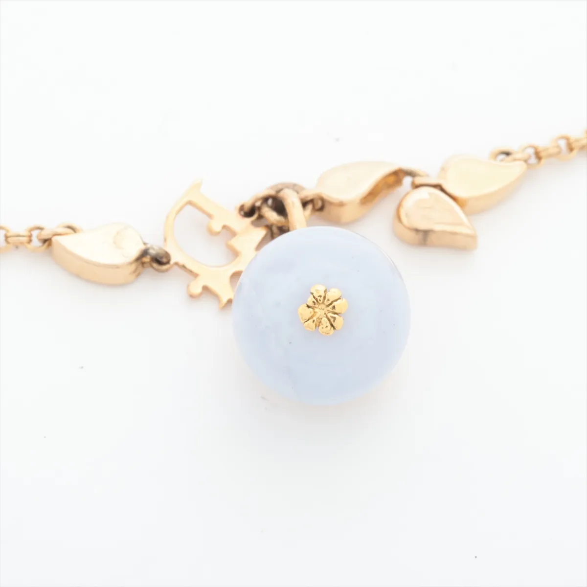 logo bracelet, gold-plated with rhinestones and colored stones, blue and gold. Shows wear, tarnishing, and discoloration. — view 3