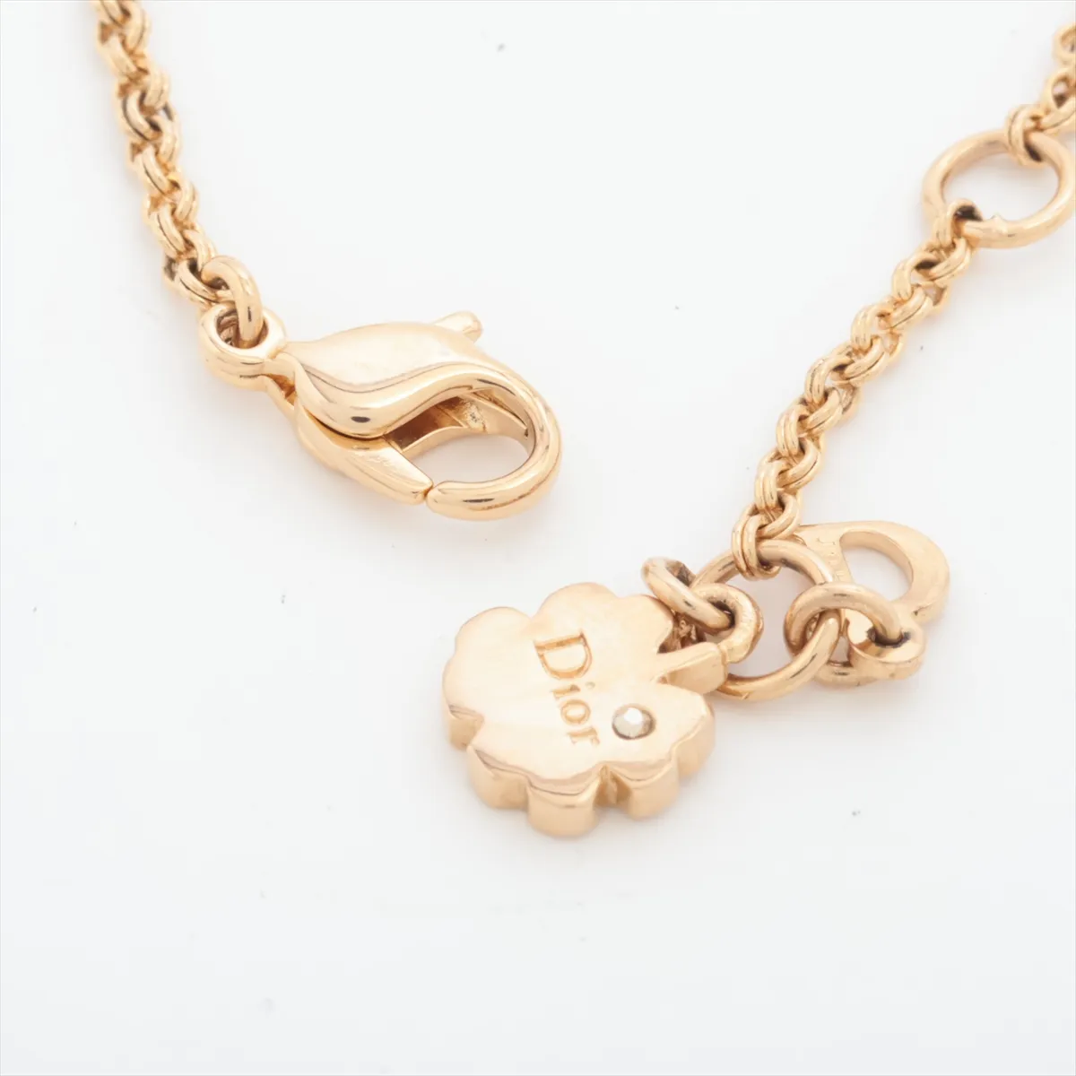 logo bracelet, gold-plated with rhinestones and colored stones, blue and gold. Shows wear, tarnishing, and discoloration. — view 4