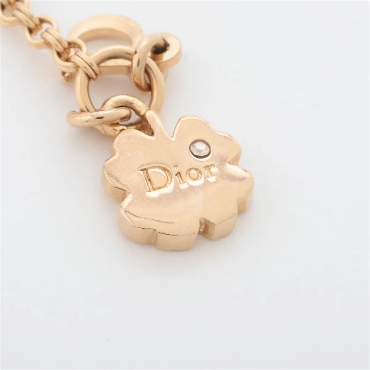 logo bracelet, gold-plated with rhinestones and colored stones, blue and gold. Shows wear, tarnishing, and discoloration. — view 5