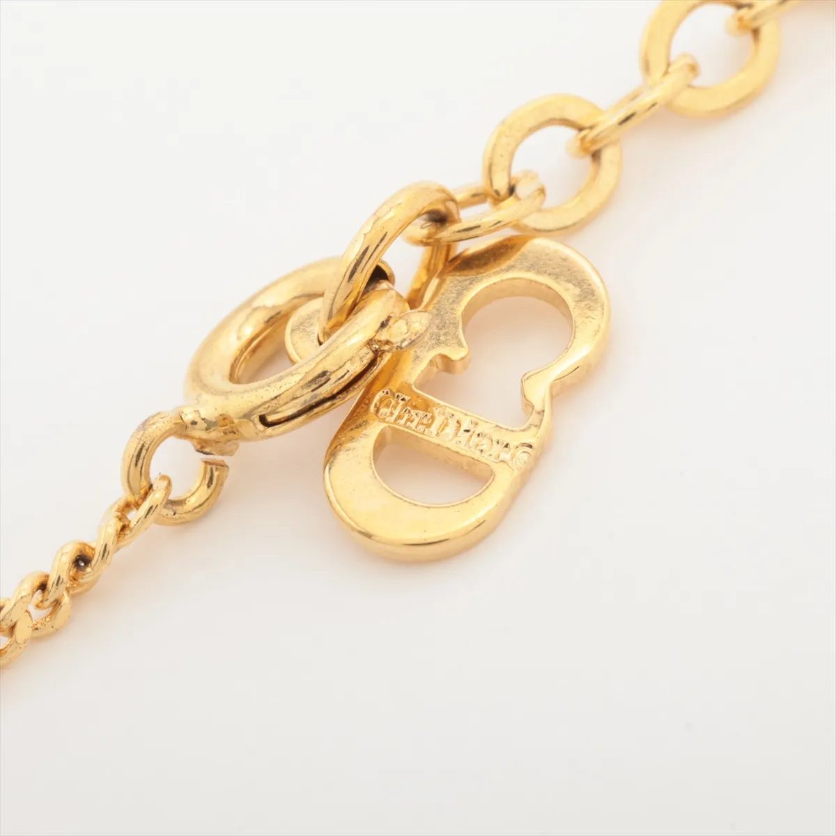 CD logo necklace, gold plated with rhinestones. Shows signs of wear, including — view 4