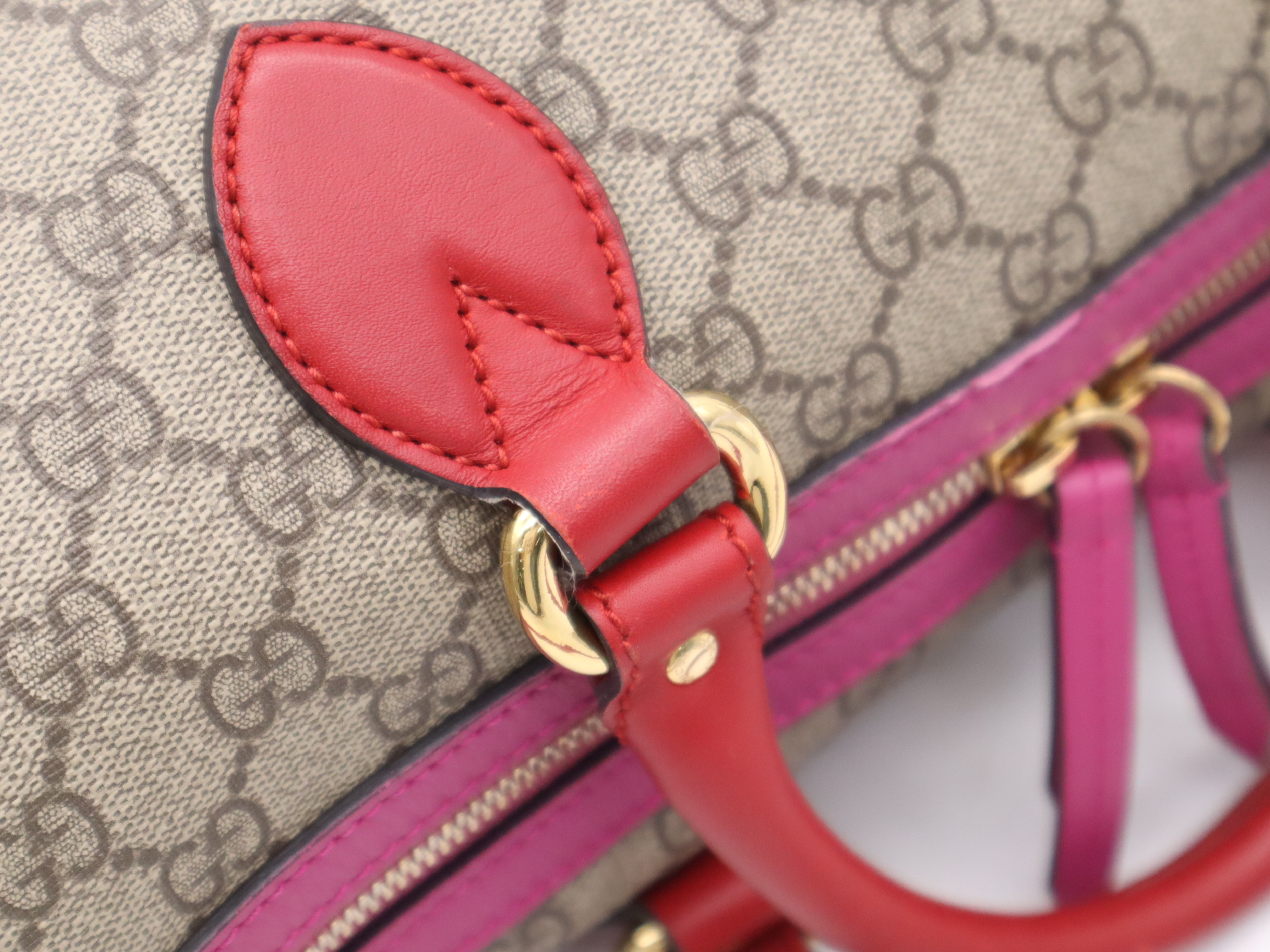 409527 GG Supreme 2-way Boston bag in beige, pink, and red with gold hardware and shoulder strap. — view 7