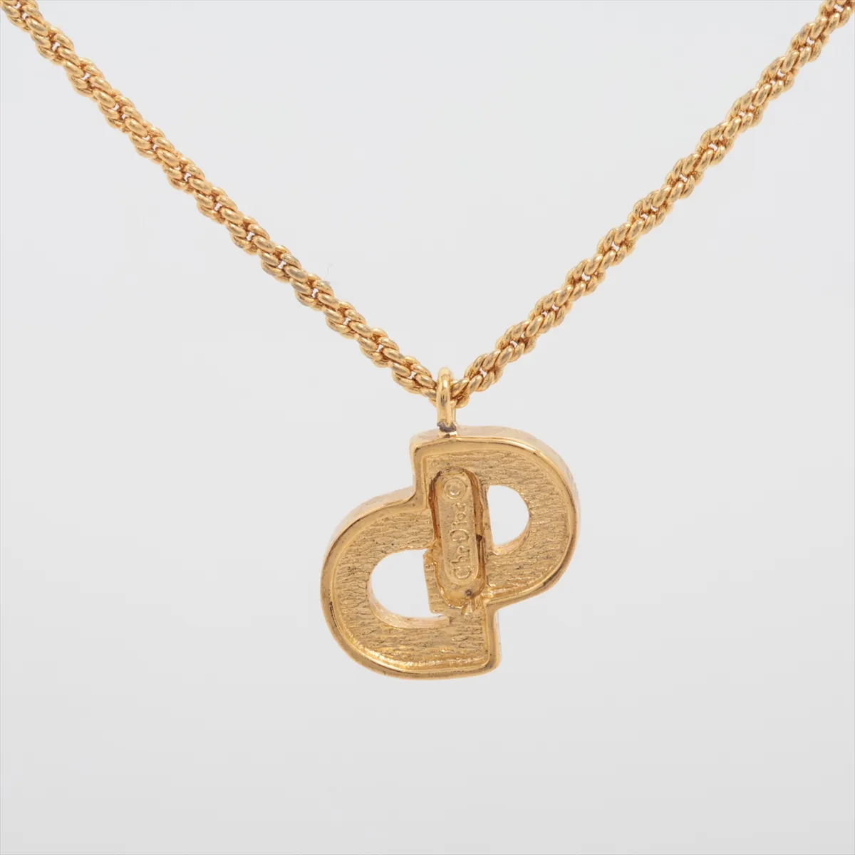 CD logo necklace, gold plated with rhinestones, shows signs of wear, tarnishing, — view 2