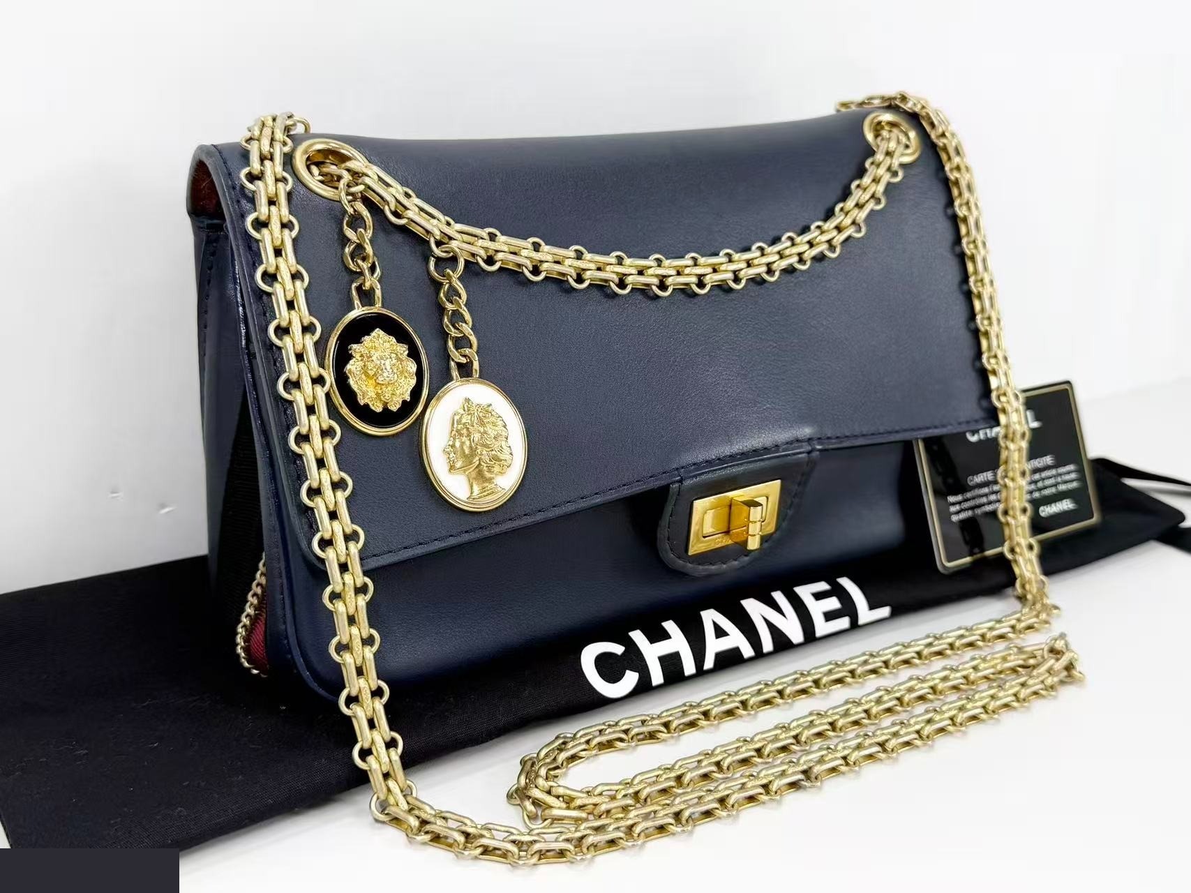 2.55 Double flap shoulder bag with medal charm, approximately 25cm wide, serial number in the 23 range. — view 2