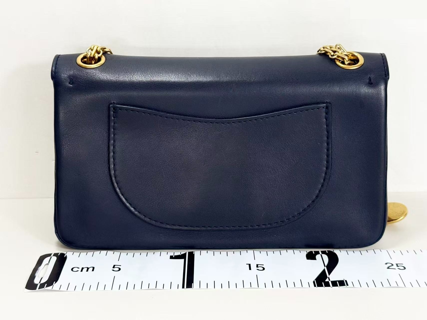 2.55 Double flap shoulder bag with medal charm, approximately 25cm wide, serial number in the 23 range. — view 3