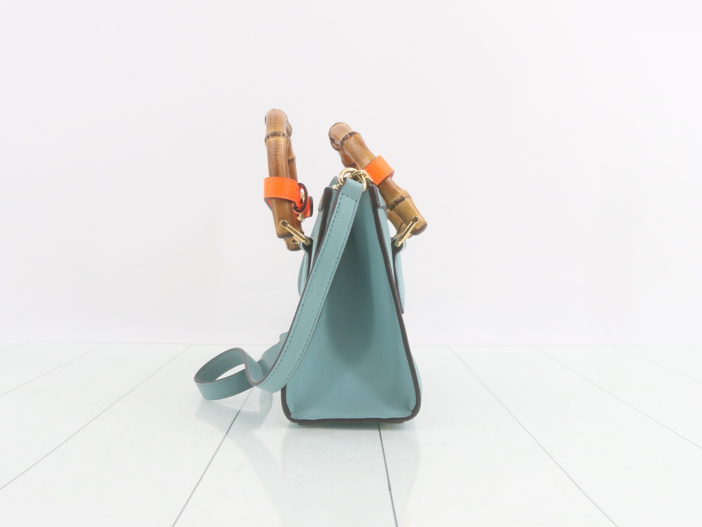 Leather and bamboo mini handbag with shoulder strap, available in blue and orange. — view 3