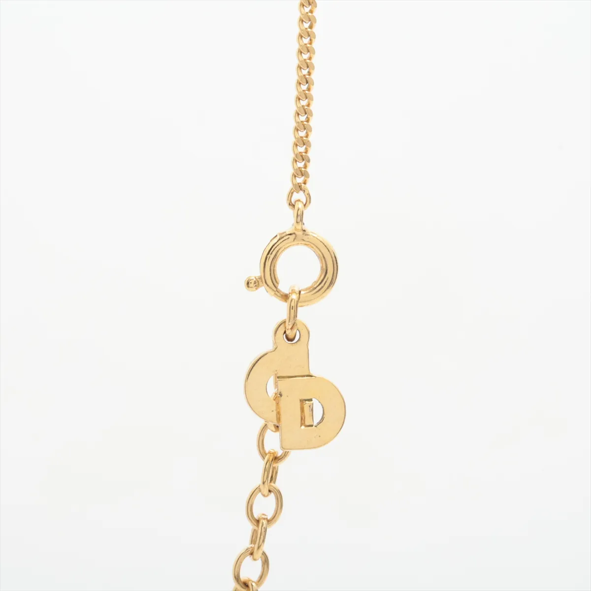 CD logo necklace, gold plated with rhinestones. Shows signs of wear, including — view 3