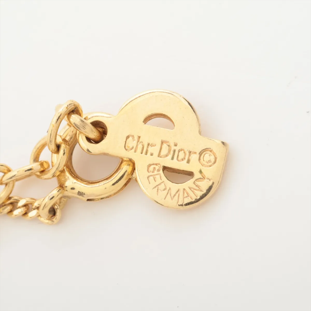 CD logo necklace, gold plated with rhinestones. Shows signs of wear, including — view 4