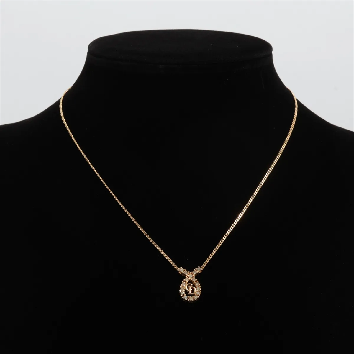 CD logo necklace, gold plated with rhinestones. Shows signs of wear, including — view 5